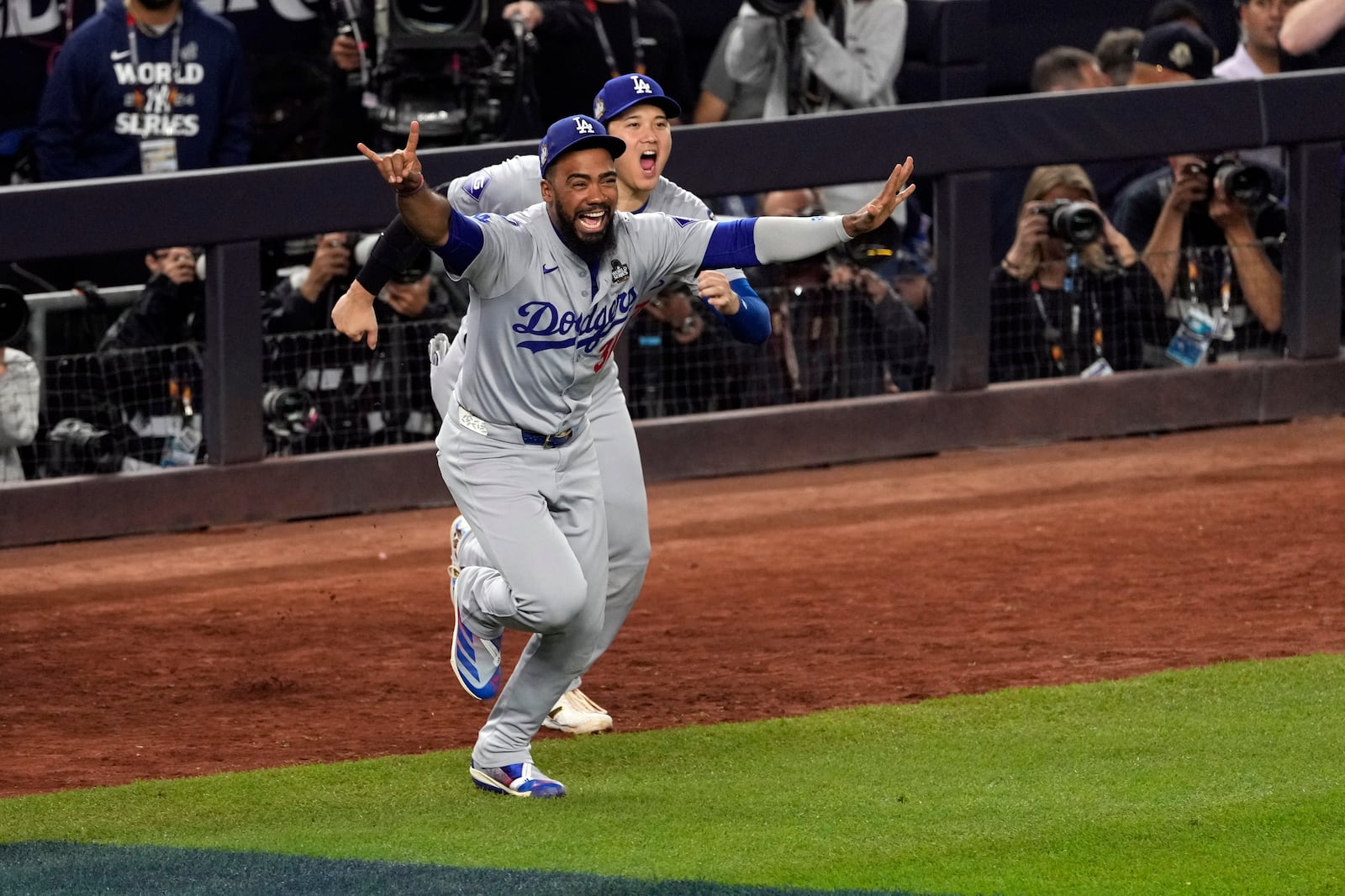 Los Angeles Dodgers' Teoscar Hernández (37) and Shohei Ohtani celebrate after the Dodgers beat the New York Yankees in Game 5 to win the baseball World Series, Wednesday, Oct. 30, 2024, in New York. (AP Photo/Seth Wenig)