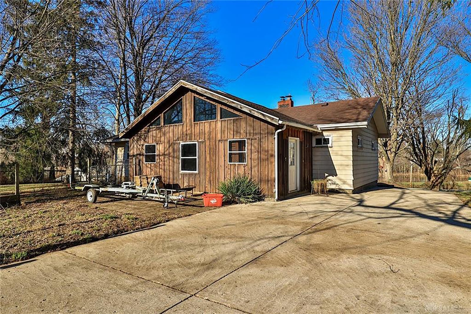 The rear of the home has a concrete patio and a paver, an enclosed patio/Florida room with vaulted ceiling and is partially fenced.