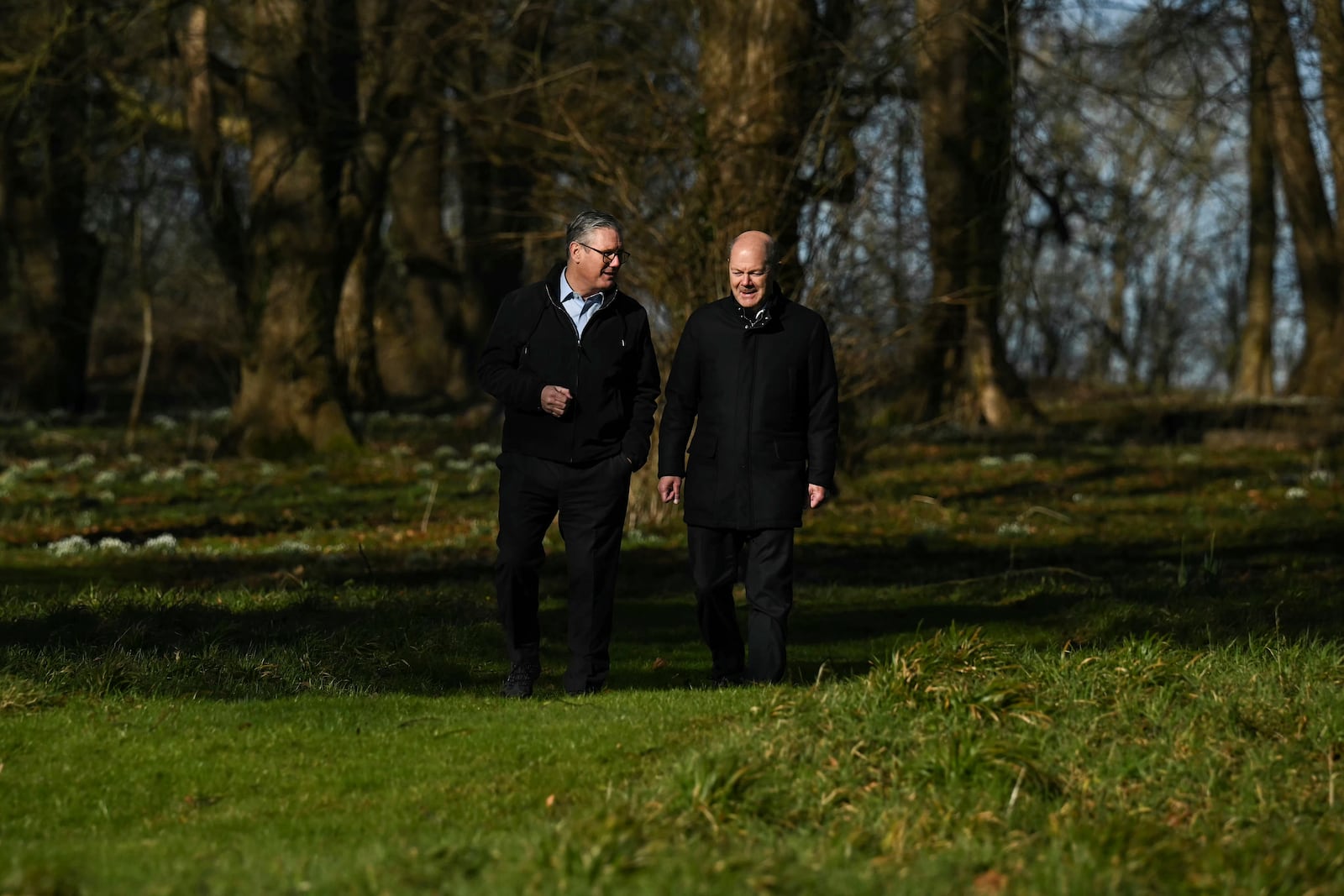 Britain's Prime Minister Keir Starmer, left, speaks with Germany's Chancellor Olaf Scholz as they have a walk in the garden of the Chequers, in Aylesbury, England, Sunday, Feb. 2, 2025. (Ben Stansall/Pool Photo via AP)