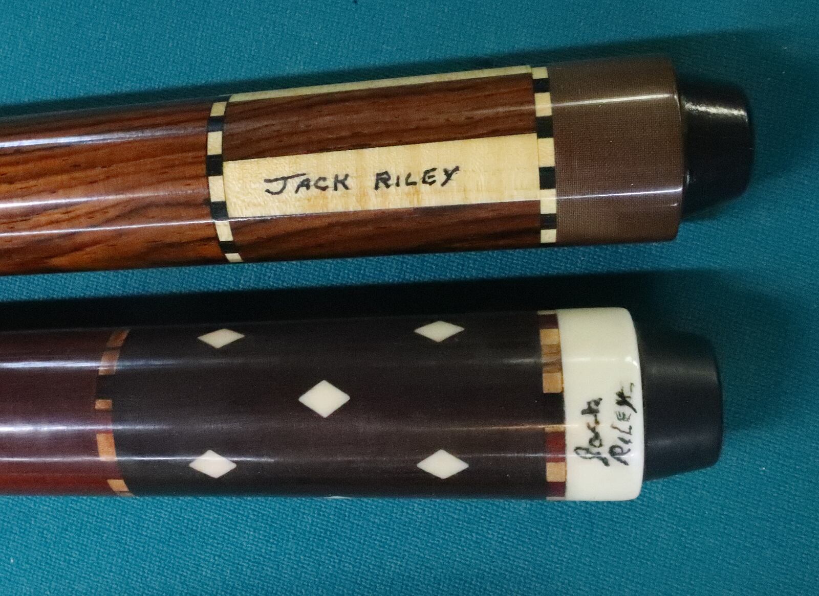 Some of the pool cues Jack Riley has made. BILL LACKEY/STAFF