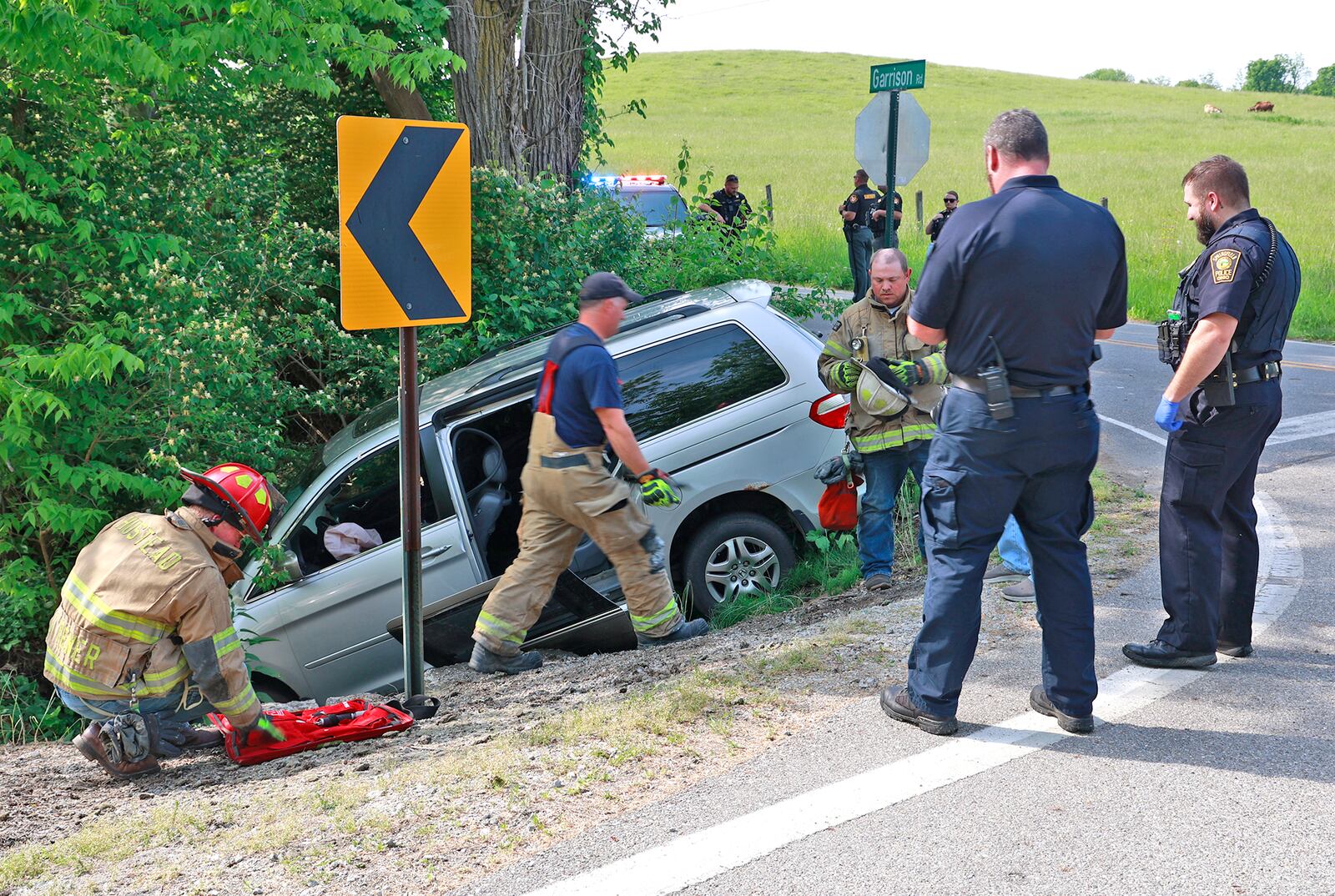 Springfield police and the Clark County Sheriff's Office investigate the scene at the intersection of Fairfield Pike and Garrison Road, where a minivan crashed Monday, May 22, 2023 while being pursued from Selma Road in Springfield. Three people reportedly were involved in the crash, and one of them was transported by medical helicopter. One was not injured and the third fled the scene and was later captured in a nearby field. A fourth individual jumped out of the car soon after the pursuit began. BILL LACKEY/STAFF