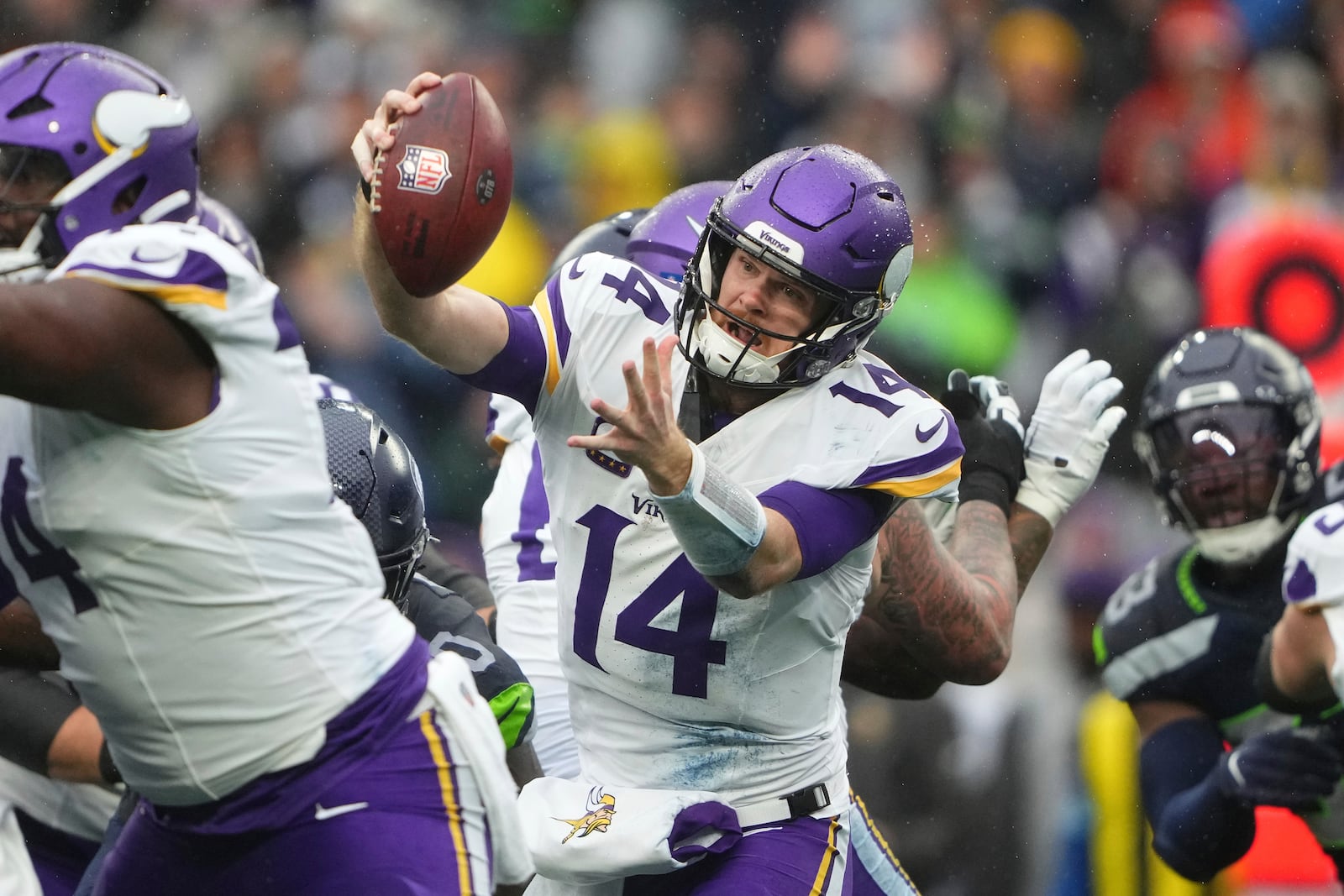 Minnesota Vikings quarterback Sam Darnold (14) is sacked by Seattle Seahawks defensive tackle Jarran Reed (90) during the first half of an NFL football game, Sunday, Dec. 22, 2024, in Seattle. (AP Photo/Lindsey Wasson)