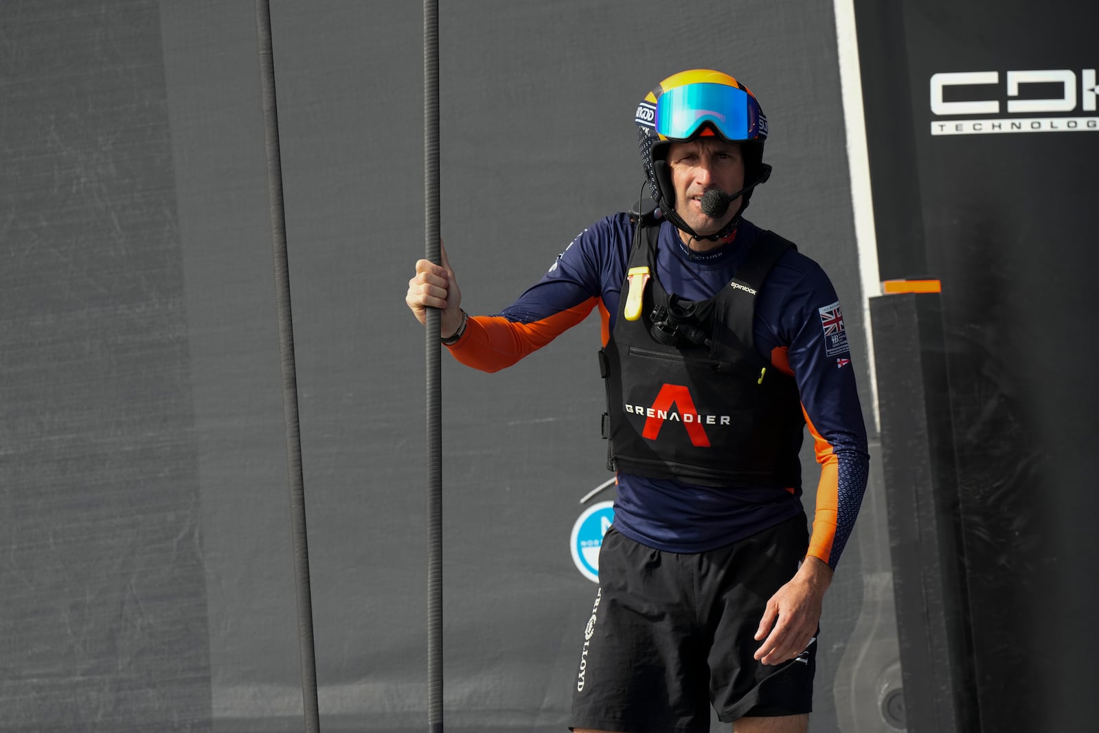 Ineos Britannia skipper Ben Ainslie, center santds before the Louis Vuitton 37th America's Cup Day 2 race in Barcelona, Spain, Sunday, Oct. 13, 2024. (AP Photo/Bernat Armangue)