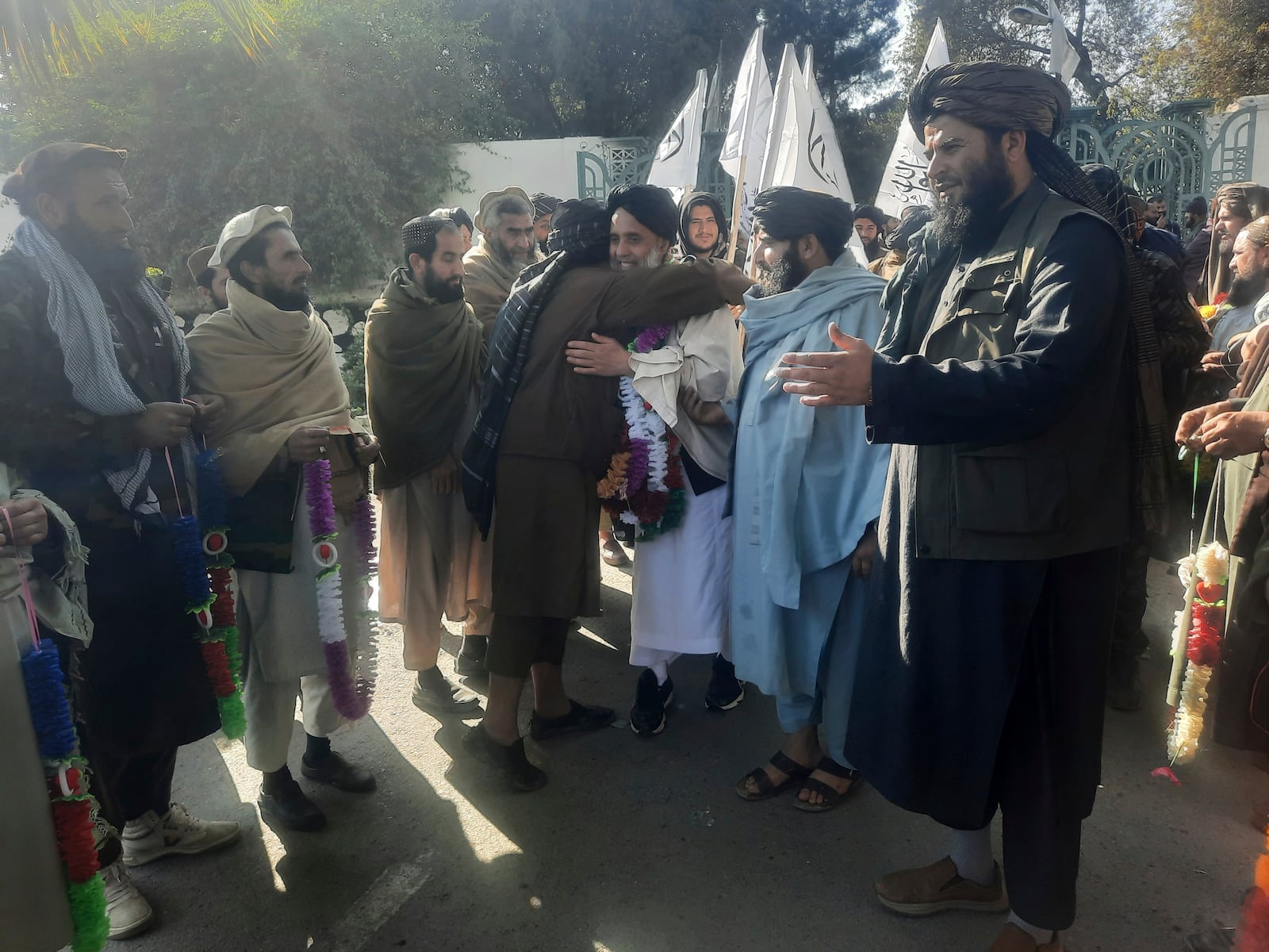 Khan Mohammed, center, is embraced in Jalal Abad, Afghanistan, after his release as part of a prisoner swap between the United States and Afghanistan's Taliban, Tuesday, Jan. 21, 2025. Mohammed, who had been sentenced in California to two terms of life imprisonment in 2008 on drug trafficking and terrorism charges, was freed in exchange for two Americans. (AP Photo/Hedayat Shah)