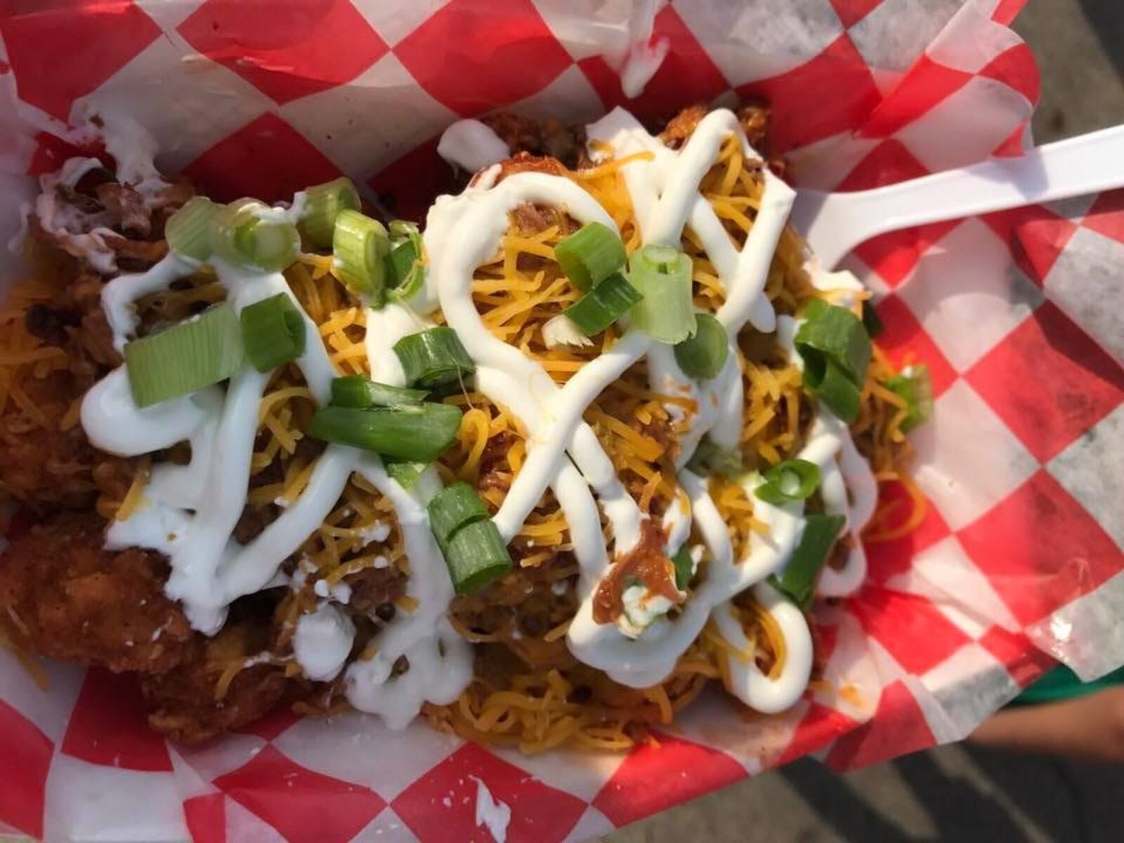 These crispy tater tots smothered in cheese, sour cream, chives and barbecue pulled pork are a must-eat food truck treasure from the Crazy Redhead Canteen. CONTRIBUTED