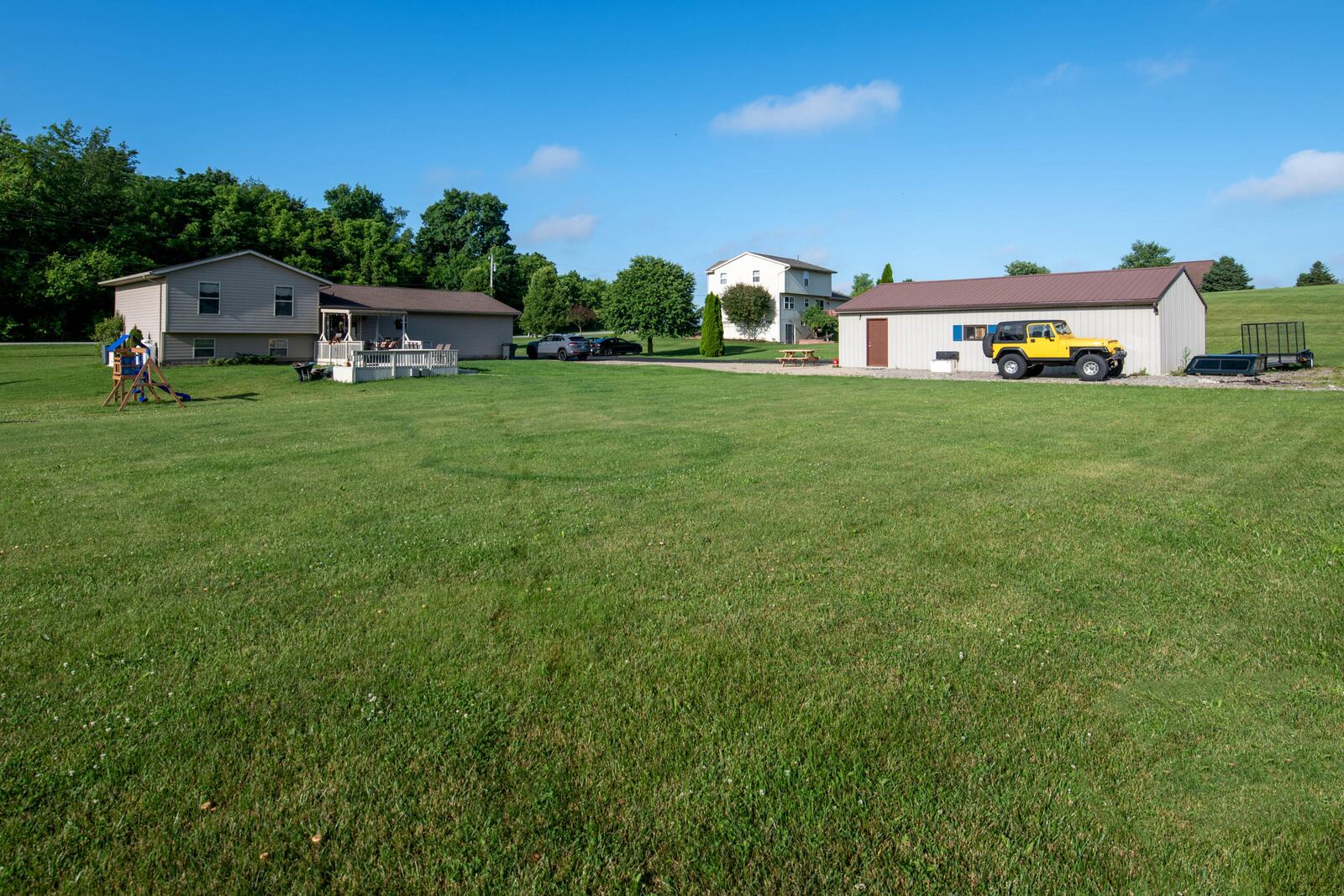 The rear features a covered deck that overlooks the large backyard and outbuilding with additional parking spaces. Beth Anspach/CONTRIBUTED