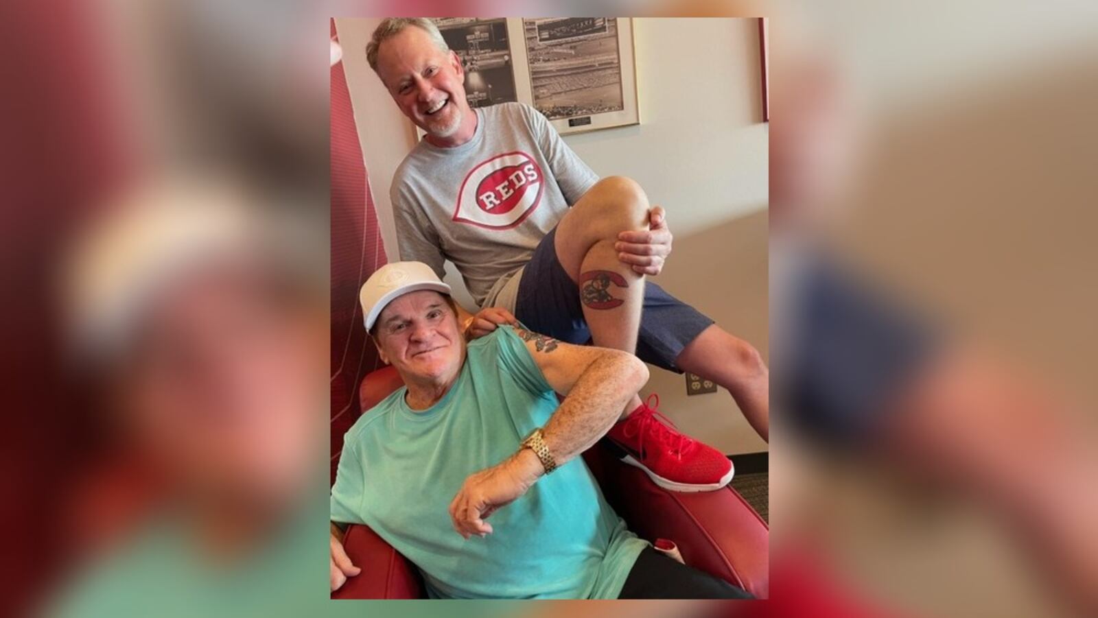 Cincinnati Reds great Pete Rose and Mark Fugate, owner of Sports Gallery, a sports memorabilia store, compare their Reds tattoos. SUBMITTED PHOTO