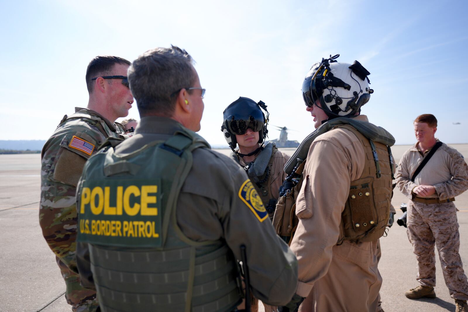 U.S. Marine pilots and U.S. Border Patrol agents interact at the Naval Outlying Landing Field Friday, Jan. 31, 2025, in Imperial Beach, Calif. (AP Photo/Jae C. Hong)