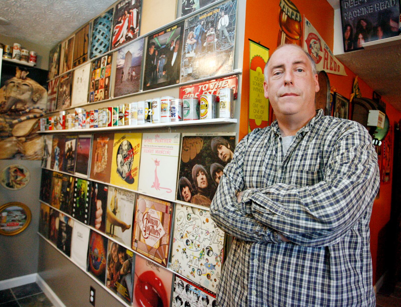 Jeff Miller of Springfield poses in the basement of his home which is decorated with record albums. Miller recalls the events of Dec. 3, 1979, when eleven people were trampled to death at a The Who concert in Cincinnati, a concert which he attended.