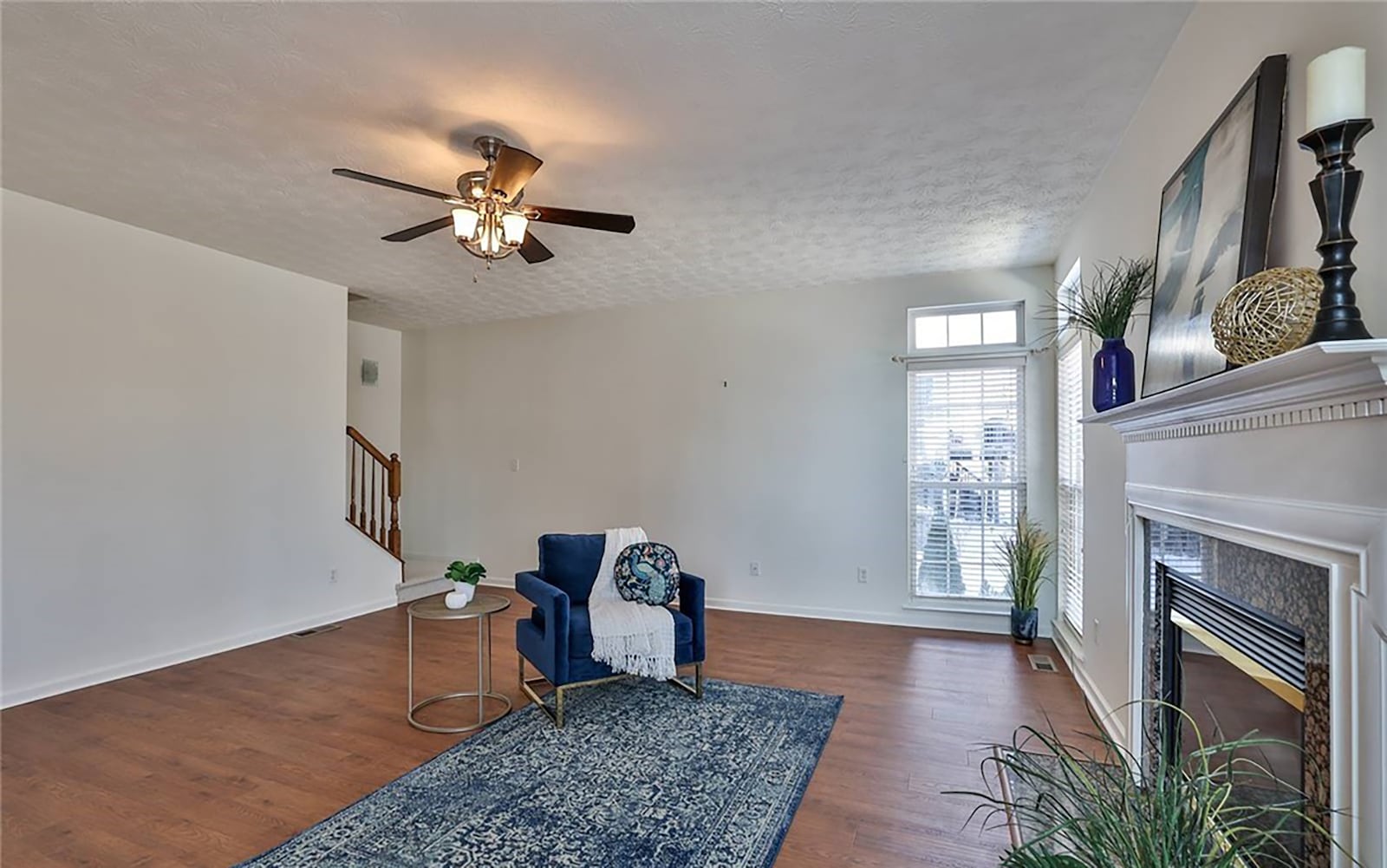 The family room has a ceiling, newer wide plank flooring and a gas fireplace. There is a rear staircase connecting this room to the upper level.