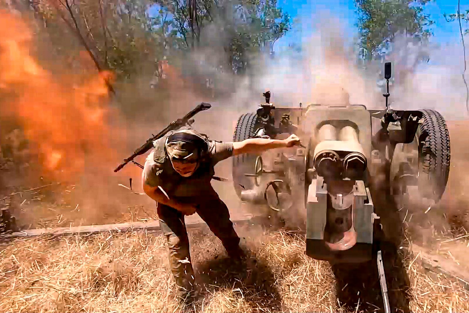 FILE - In this photo taken from a video released by the Russian Defense Ministry on Thursday, Aug. 22, 2024, a Russian soldier fires from D-30 howitzer towards Ukrainian positions in an undisclosed location in Ukraine. (Russian Defense Ministry Press Service via AP, File)