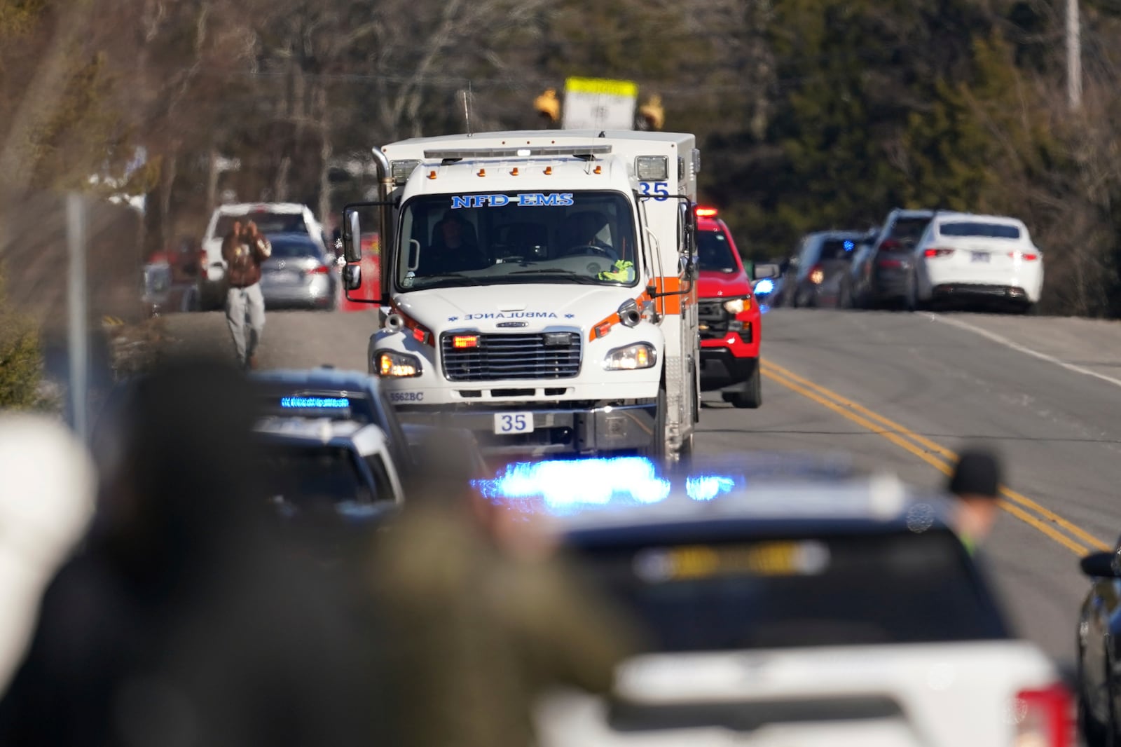 An ambulance leaves the Antioch High School following a shooting in Nashville, Tenn., Wednesday, Jan. 22, 2025. (AP Photo/George Walker IV)