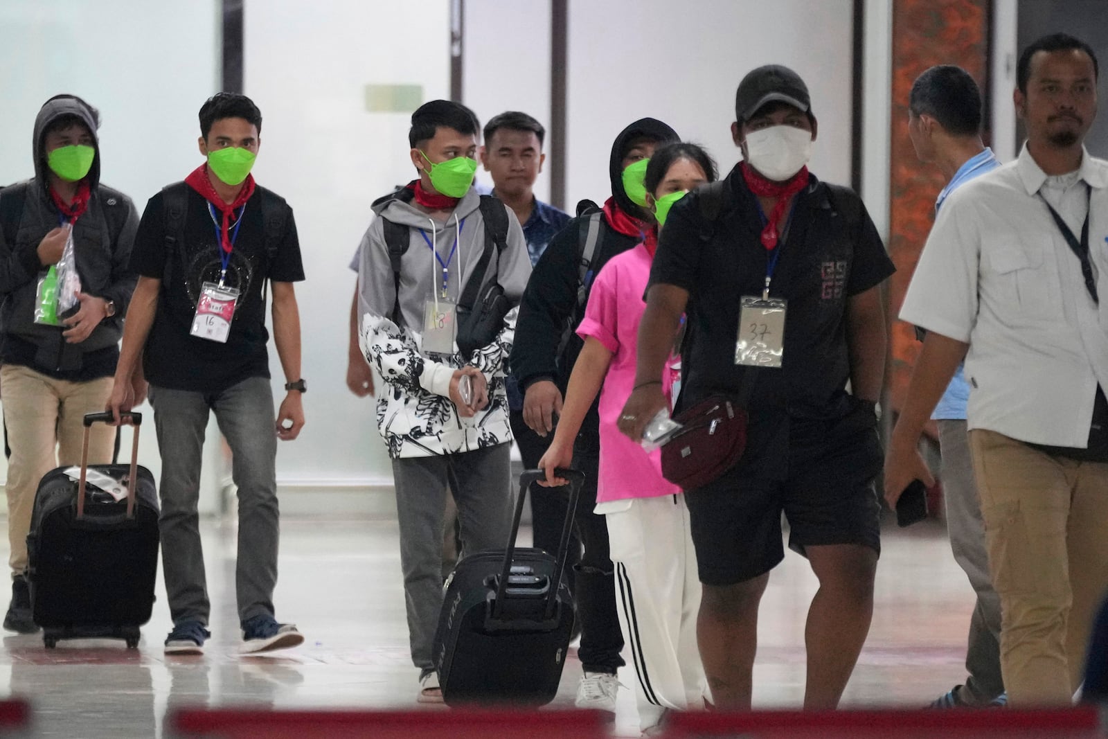 FILE- Indonesians who were forced to work at scam centers in eastern Myanmar arrive at Soekarno-Hatta International Airport in Tangerang, Indonesia, Friday, Feb. 28, 2025.(AP Photo/Tatan Syuflana, File)