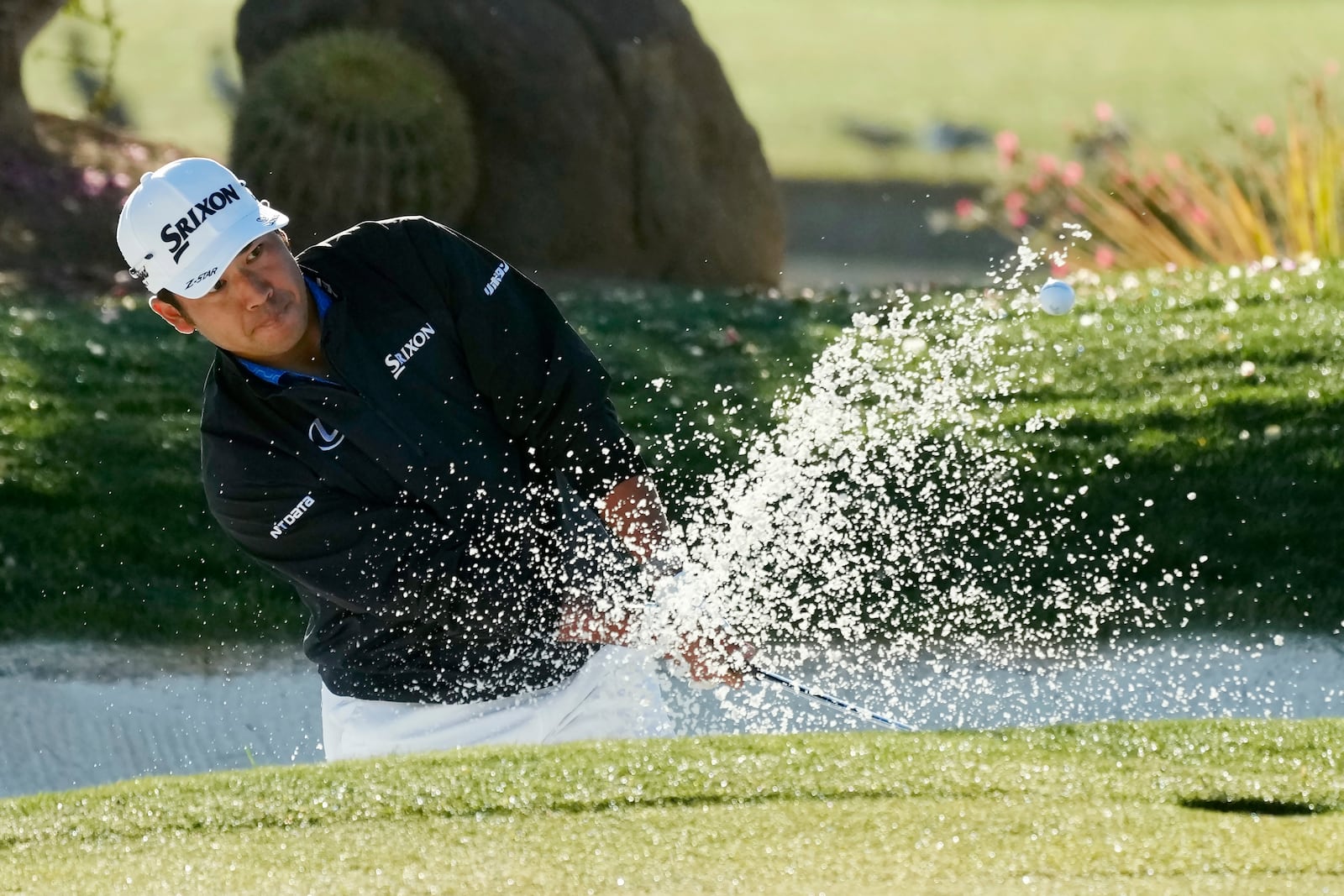 Hideki Matsuyama, of Japan, hits out of a bunker on the 12th hole during the first round of the Waste Management Phoenix Open PGA Tour golf tournament at the TPC Scottsdale Thursday, Feb. 6, 2025, in Scottsdale, Ariz. (AP Photo/Ross D. Franklin)