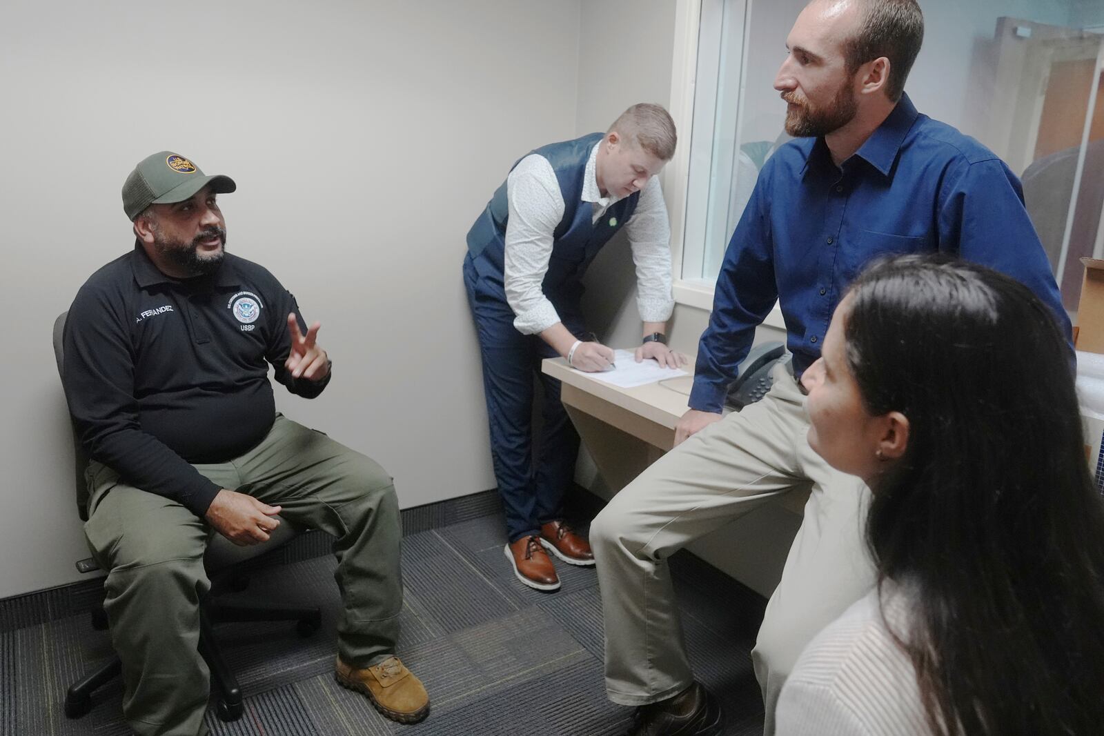 Federal Wildlife Officer Cody Smith and Border Patrol processing coordinator Yaira Santiago listen to Border Patrol agent Andry Fernandez during a training scenario where they practice their new chaplain skills, Wednesday, Nov. 20, 2024, in Dania Beach, Fla. (AP Photo/Marta Lavandier)