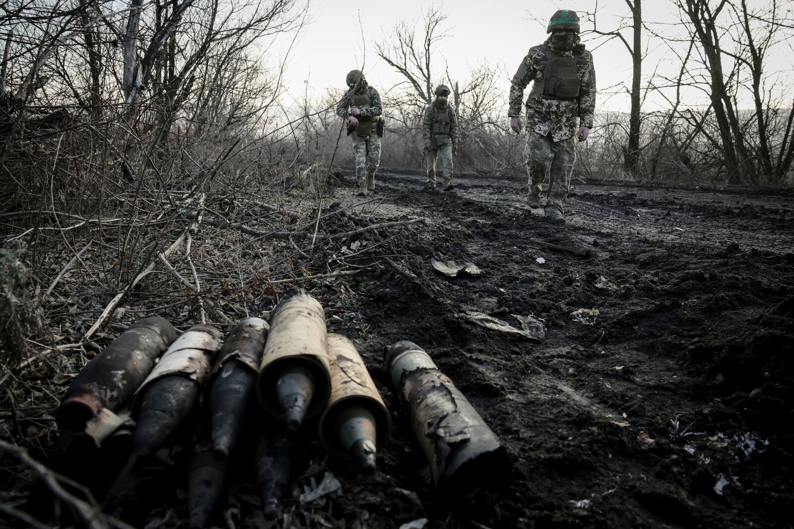 Ukrainian servicemen collect damaged ammunition on the road at the front line near Chasiv Yar town, in Donetsk region, Ukraine, Ukraine, Friday, Jan. 10, 2025. (Oleg Petrasiuk/Ukraine's 24th Mechanised Brigade via AP)