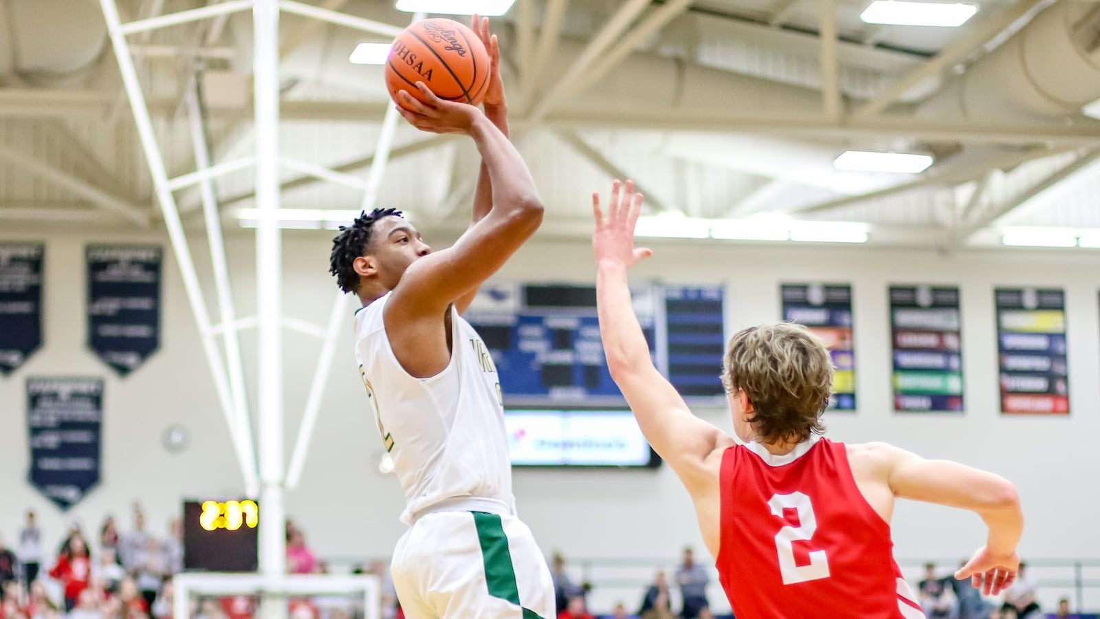 Catholic Central’s Sabien Doolittle shoots the ball over St. Henry’s Jay Knapke during a Division IV regional semifinal game at Trent Arena in Kettering. CONTRIBUTED PHOTO BY MICHAEL COOPER