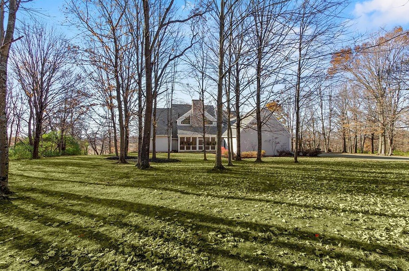 The rear of the home has a sunroom and three-car, side-entry attached garage.