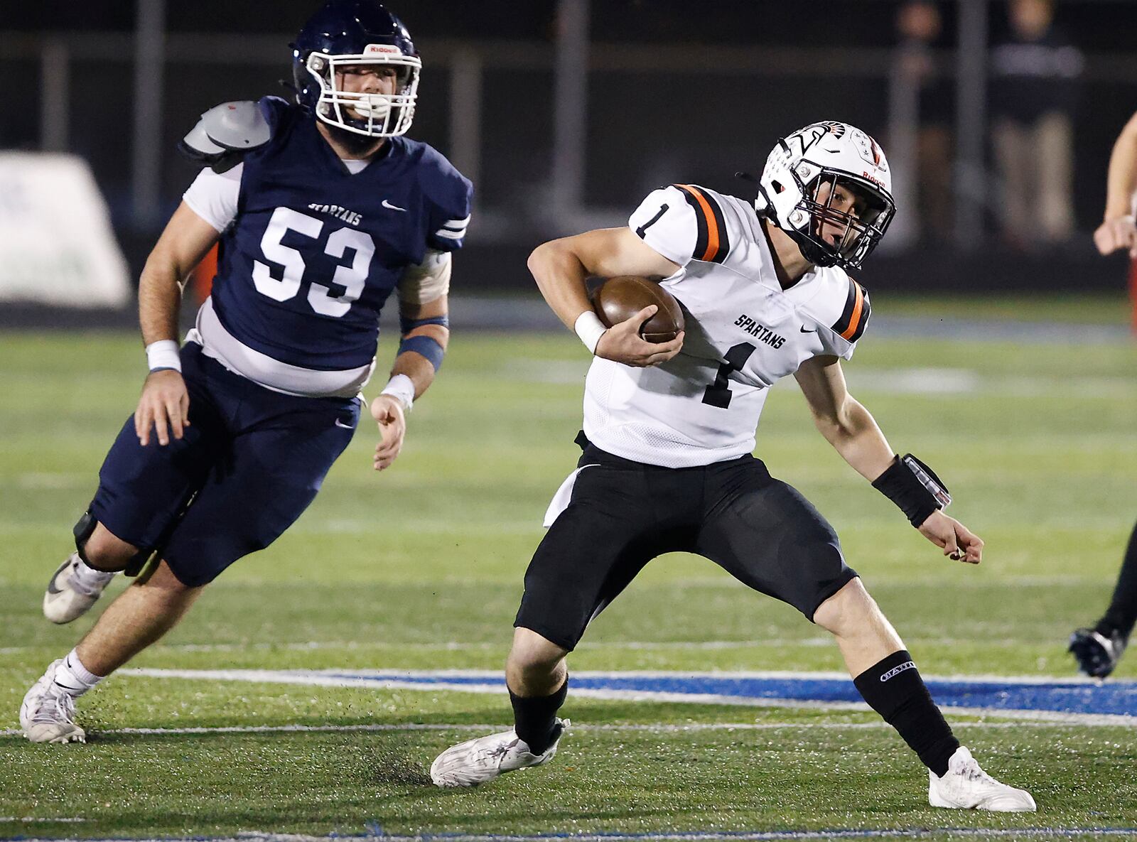 Waynesville's Alex Amburgy carries the ball as he's pursued by Valley View's Peyton Flannery during Friday's playoff game. BILL LACKEY/STAFF