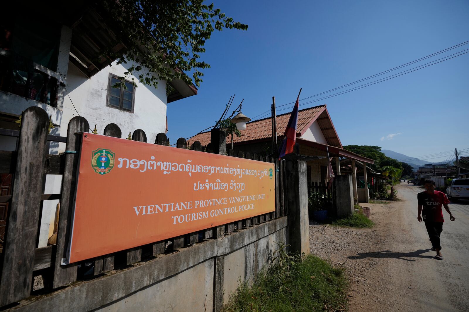 A man walks past the tourism control police station in Vang Vieng, Laos, Friday, Nov. 22, 2024. (AP Photo/Anupam Nath)