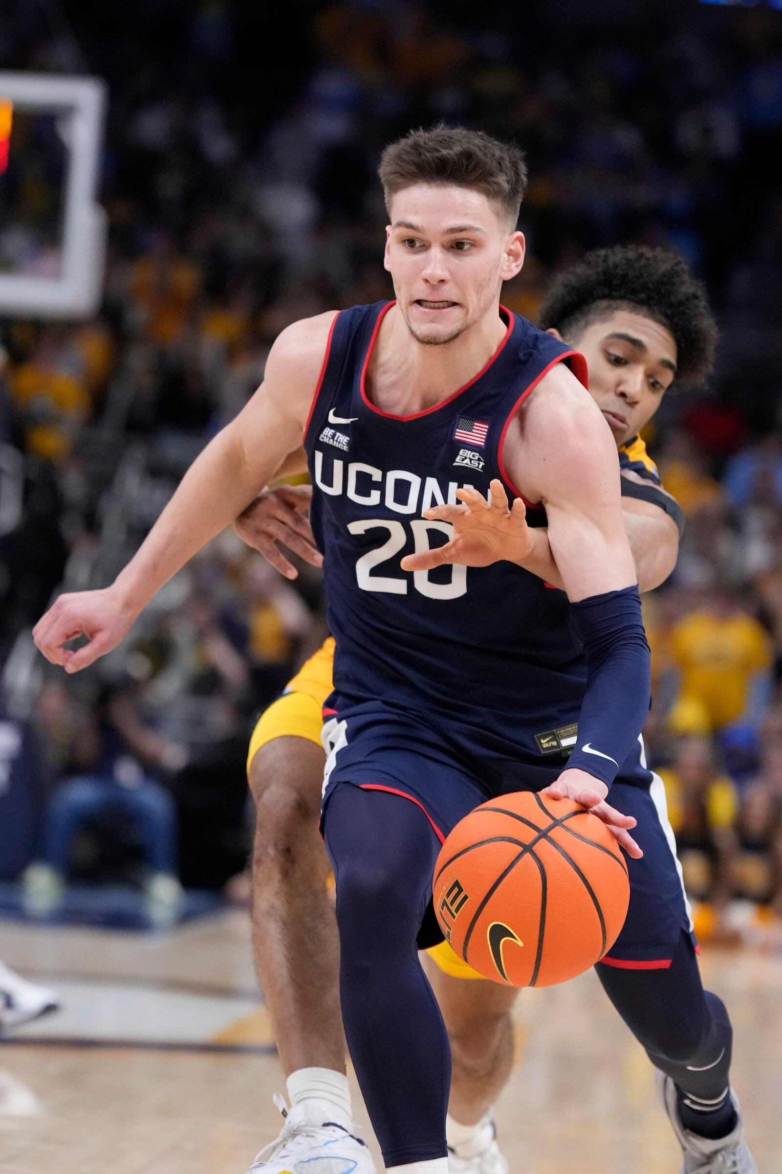 UConn's Aidan Mahaney gets past Marquette's Stevie Mitchell during the second half of an NCAA college basketball game Saturday, Feb. 1, 2025, in Milwaukee. (AP Photo/Morry Gash)