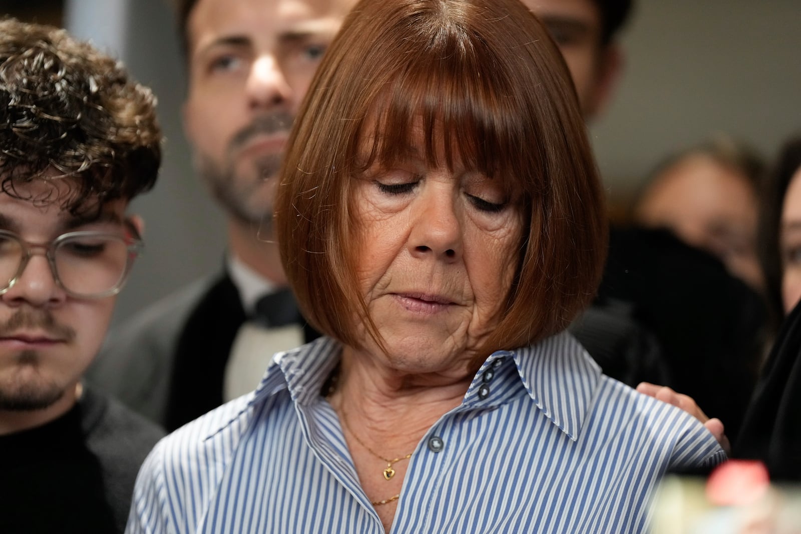 Gisele Pelicot speaks to the press as she leaves the courtroom, in the Avignon courthouse, southern France, Thursday, Dec. 19, 2024. (AP Photo/Lewis Joly)