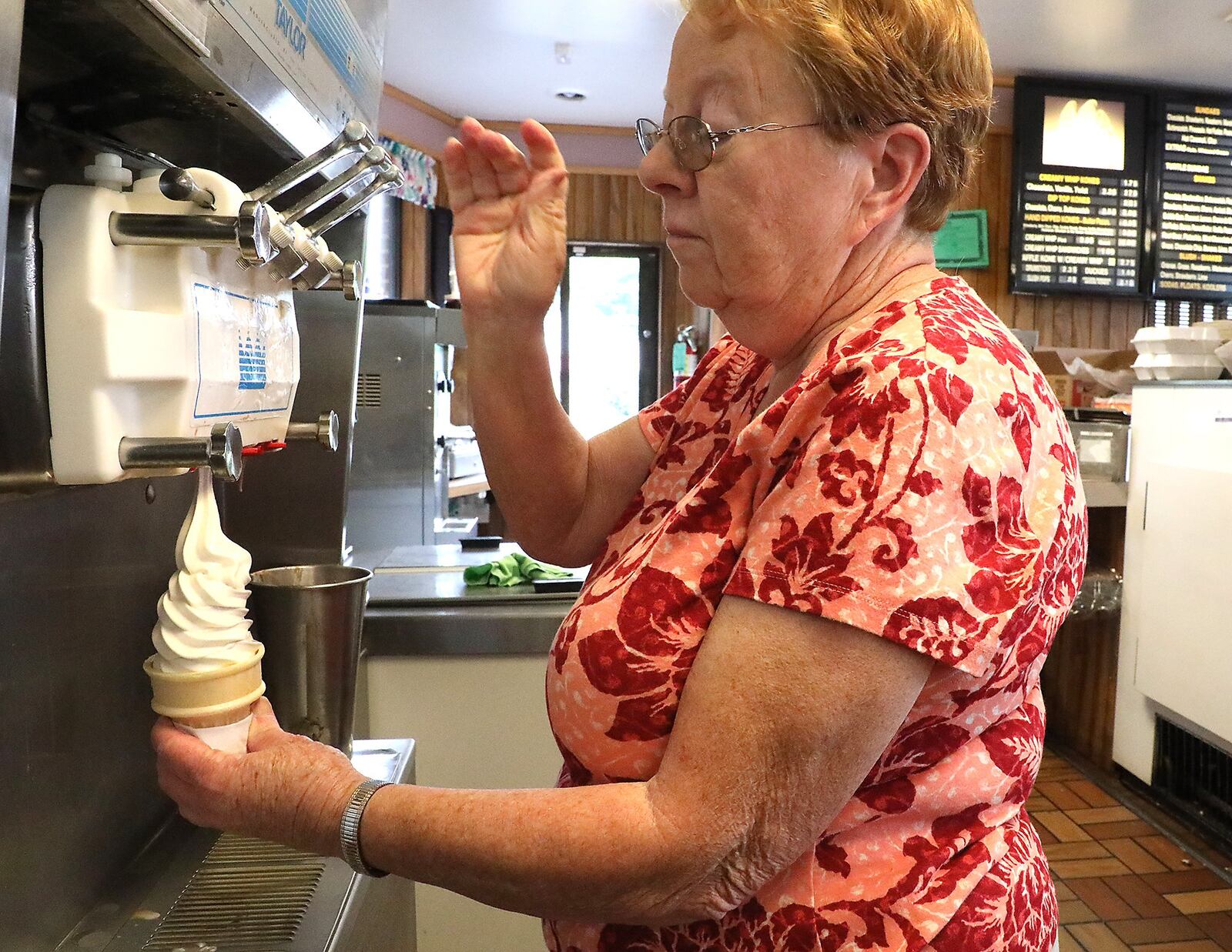 Marilyn Stanley, the owner of the Kone Korner, makes a softserve ice cream cone. BILL LACKEY/STAFF