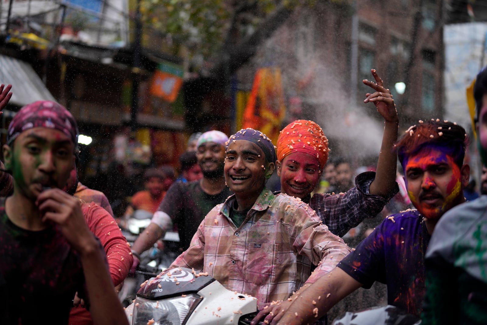 Indians play with colours as they celebrate Holi in Jammu, India, Friday, March 14, 2025. (AP Photo/Channi Anand)