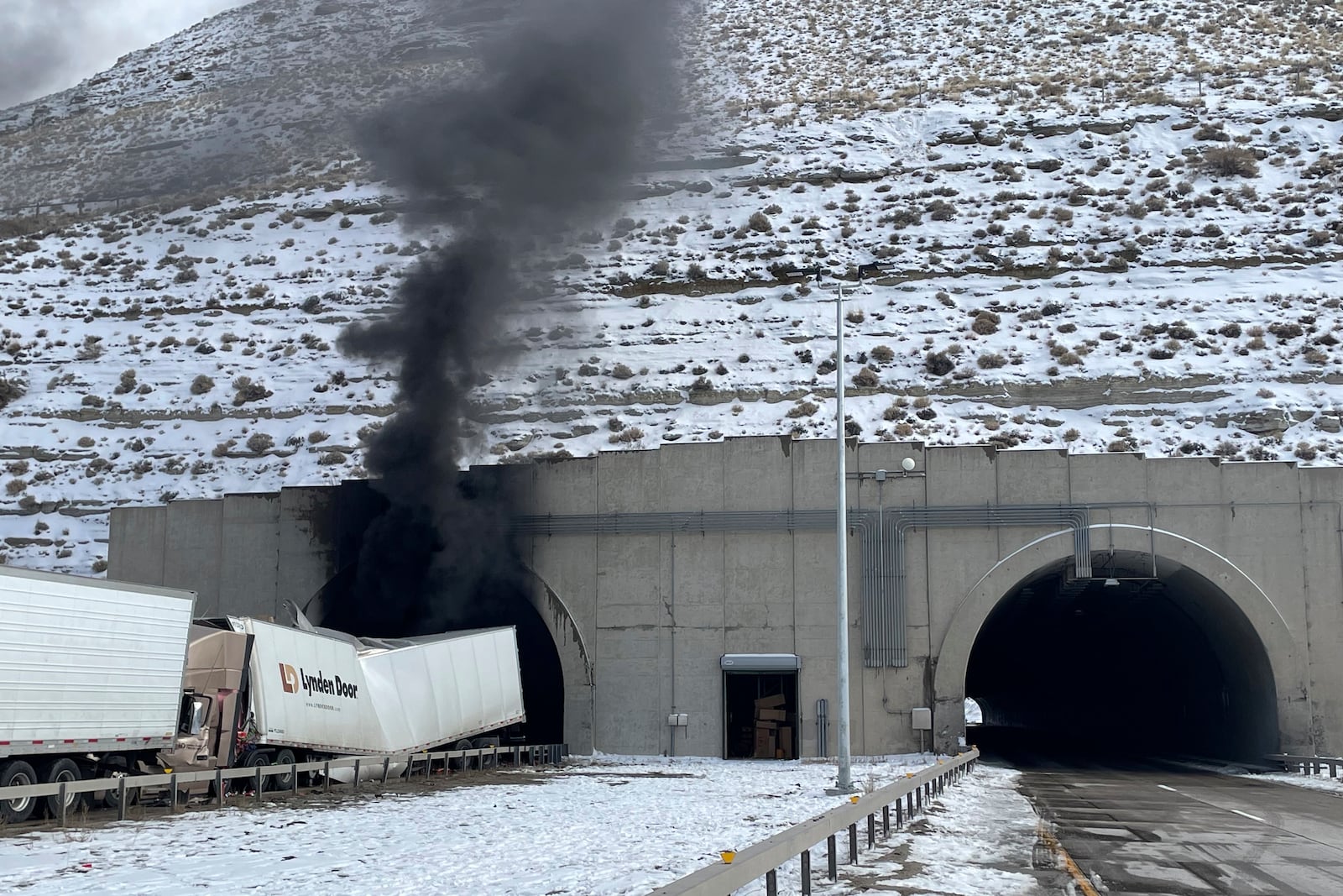 This photo provided by the Wyoming Highway Patrol shows smoke from a multiple-vehicle crash in the westbound tunnel of Interstate-80 in Green River, Wyo., on Friday, Feb. 14, 2025. (Wyoming Highway Patrol via AP)