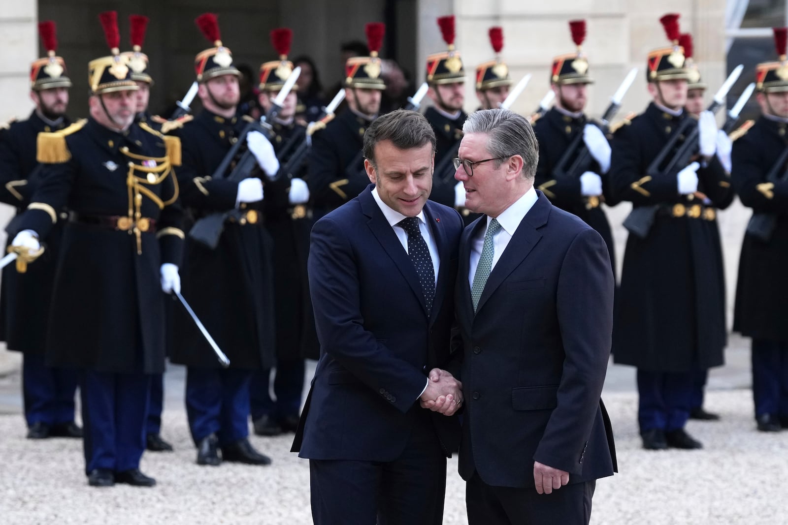 French President Emmanuel Macron, left, greets Britain's Prime Minister Keir Stammer as he arrives for an informal meeting of leaders from key European Union nations and the United Kingdom at the Elysee Palace in Paris, Monday, Feb. 17, 2025. (AP Photo/Aurelien Morissard)