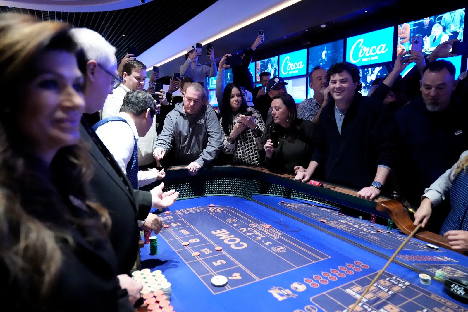 Guests watch as President Donald Trump stands at a craps table after speaking about the economy at the Circa Resort and Casino in Las Vegas, Saturday, Jan. 25, 2025. (AP Photo/Mark Schiefelbein)