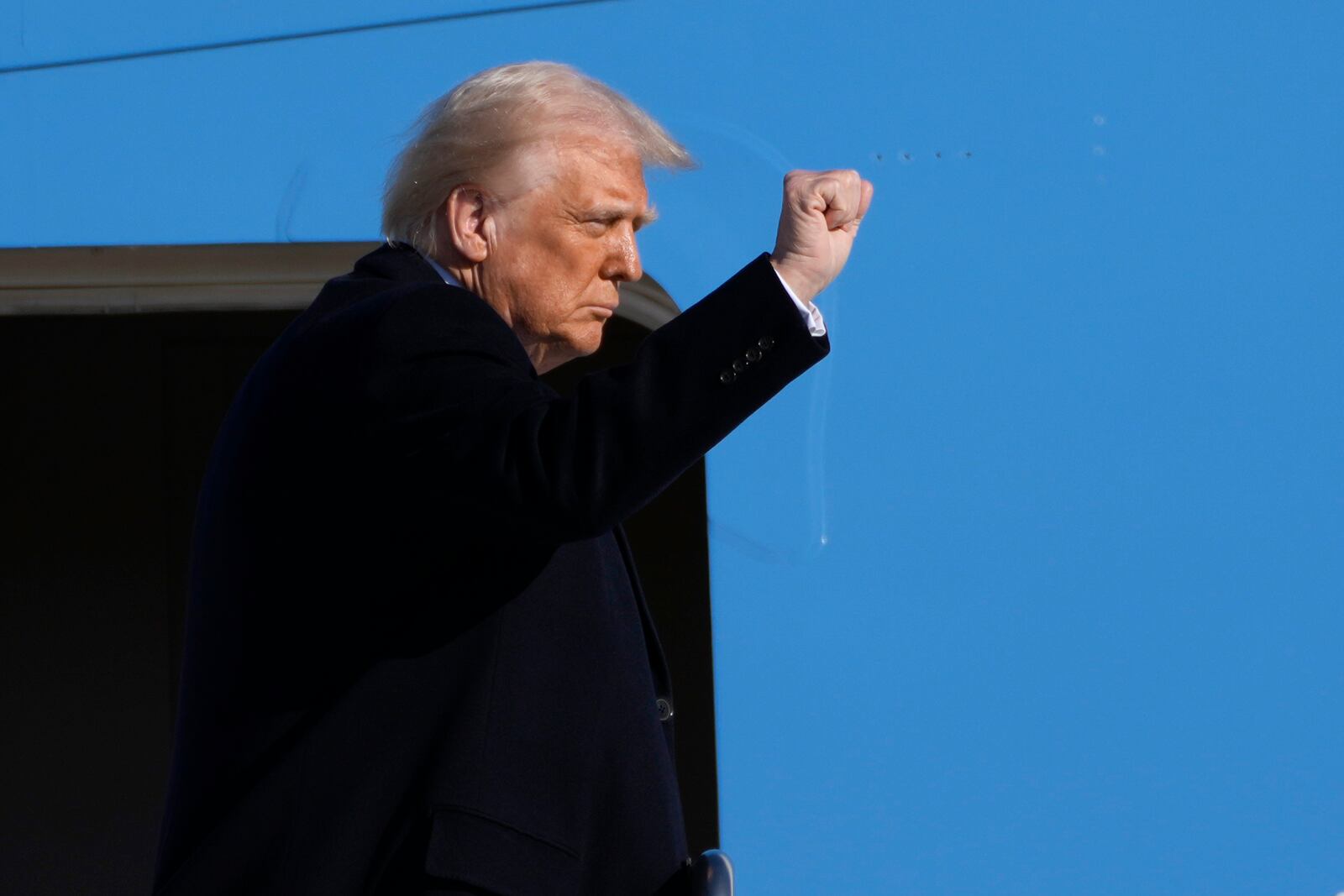 President Donald Trump gestures as he boards Air Force One at Joint Base Andrews, Md., Friday, Feb. 14, 2025, en route to West Palm Beach, Fla. (AP Photo/Ben Curtis)