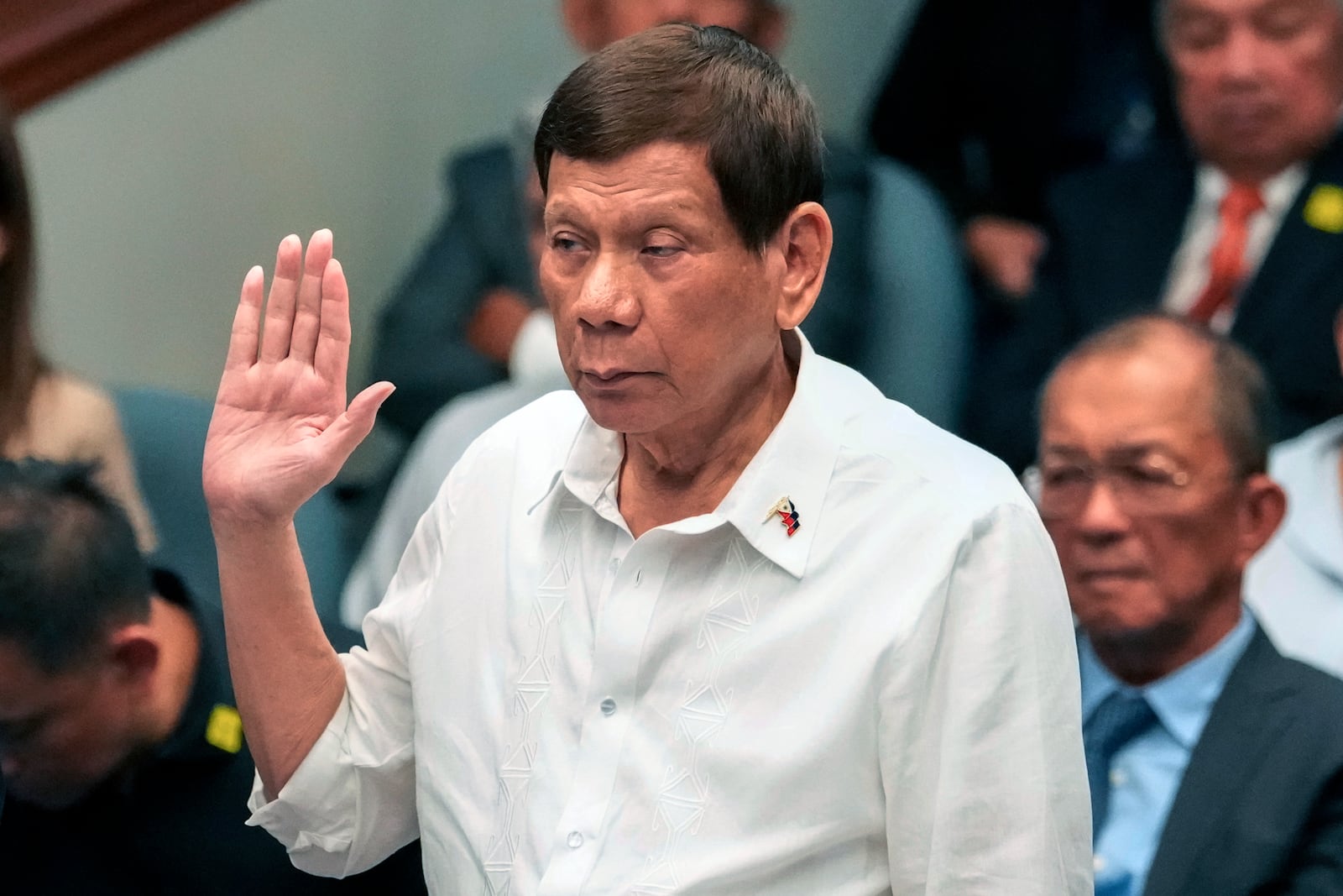 Former Philippine President Rodrigo Duterte takes oath during a senate inquiry on the so-called war on drugs during his administration at the Philippine Senate Monday, Oct. 28, 2024, in Manila, Philippines. (AP Photo/Aaron Favila)