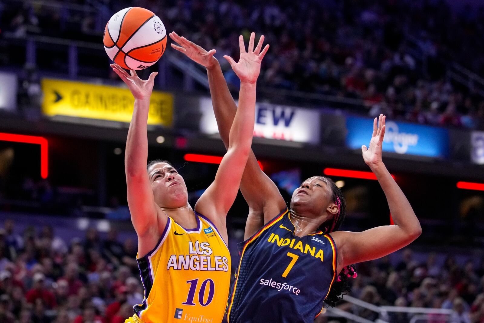 FILE - Los Angeles Sparks guard Kia Nurse (10) shoots over Indiana Fever forward Aliyah Boston (7) in the first half of a WNBA basketball game in Indianapolis, Wednesday, Sept. 4, 2024. (AP Photo/Michael Conroy, FIle)