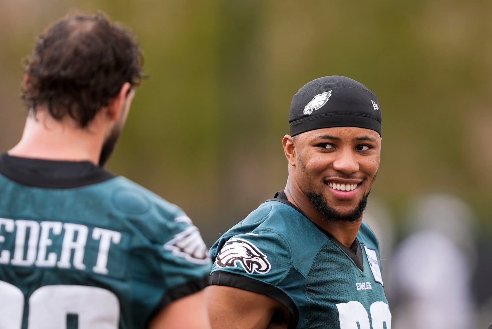 Philadelphia Eagles running back Saquon Barkley talks with tight end Dallas Goedert during an NFL football practice Thursday, Feb. 6, 2025, in New Orleans, ahead of Super Bowl 59 against the Kansas City Chiefs. (AP Photo/Gerald Herbert)