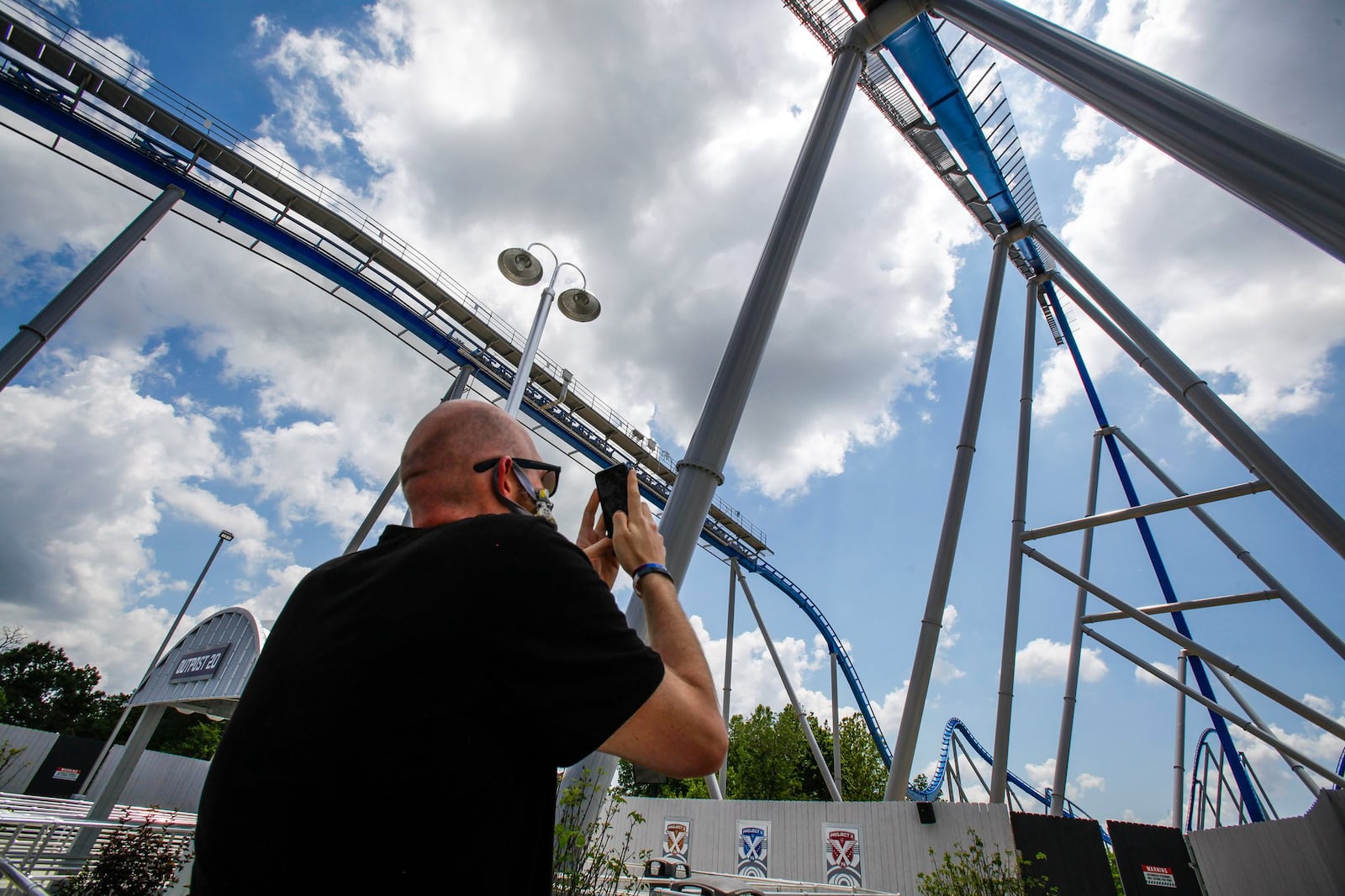 Coaster enthusiast Jared Ream stands with the new Orion giga coaster in the background on media day on July 1 at Kings Island in Mason. Ream lost 190 pounds, motivated by his desire to ride this coaster. NICK GRAHAM / STAFF