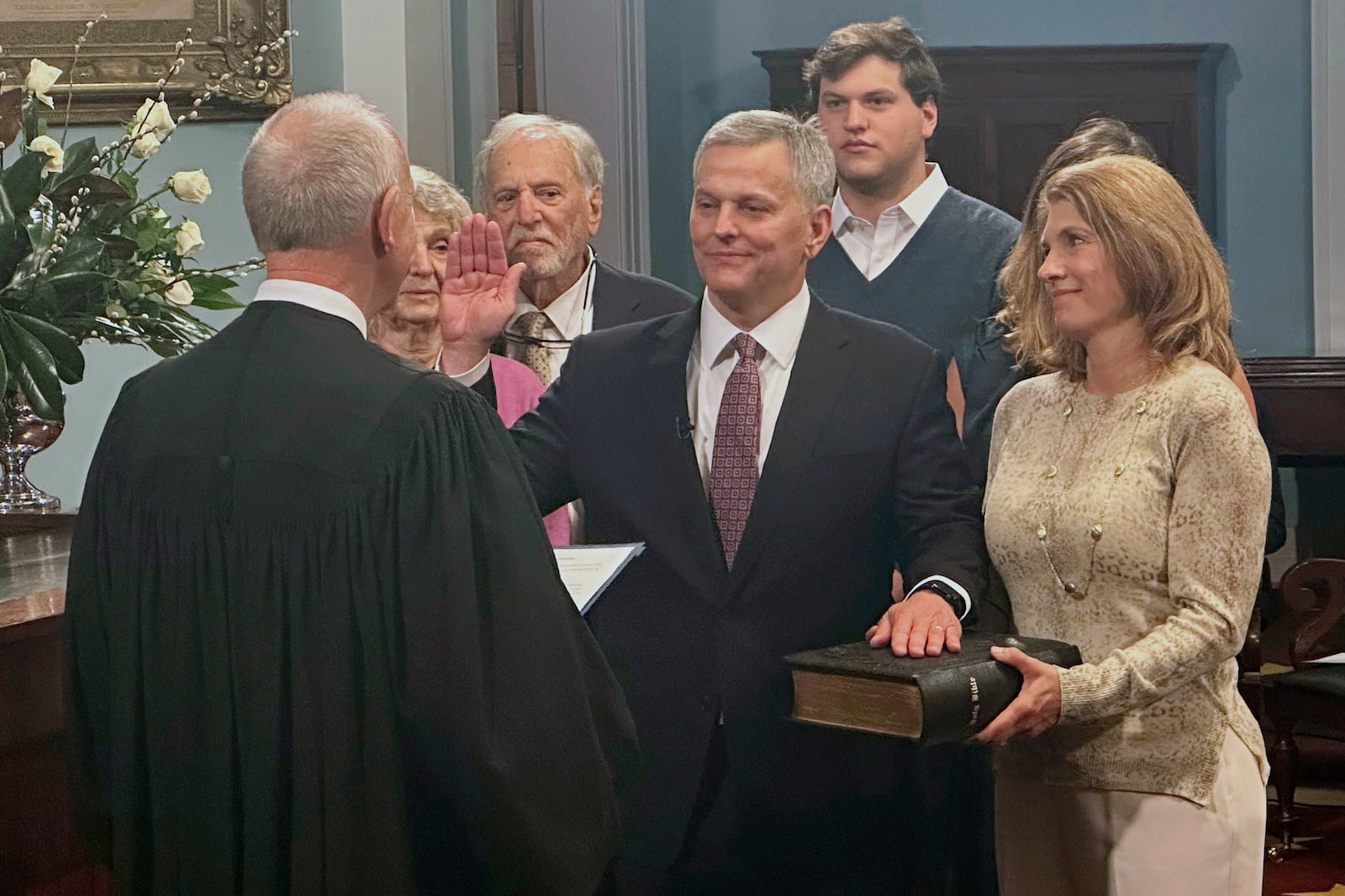 North Carolina Gov. Josh Stein, center, takes the oath of office from state Supreme Court Chief Justice Paul Newby, placing his hand on the Hebrew Bible held by Stein's wife, Anna, in the old Senate chamber of the 1840 Capitol Building in Raleigh, N.C. on Wednesday, Jan. 1 ,2025 (AP Photo/Gary D. Robertson)