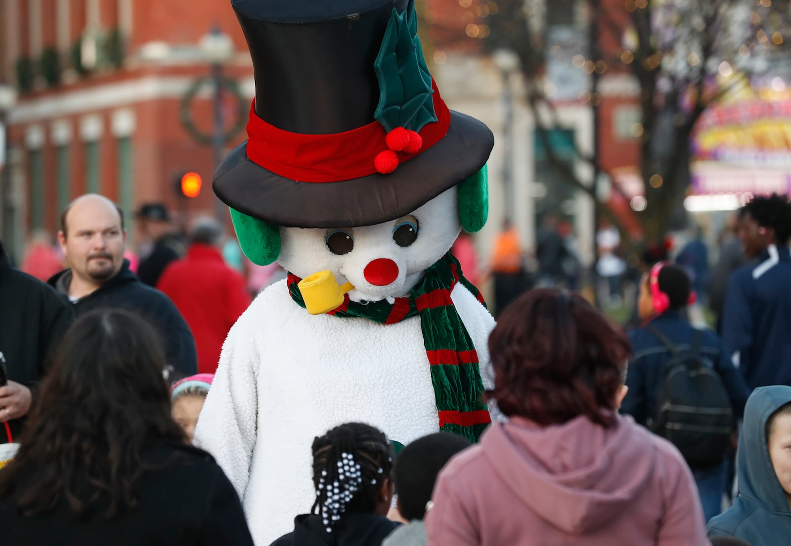 Frosty the Snowman walks through the crowd Saturday during Holiday in the City. Bill Lackey/Staff