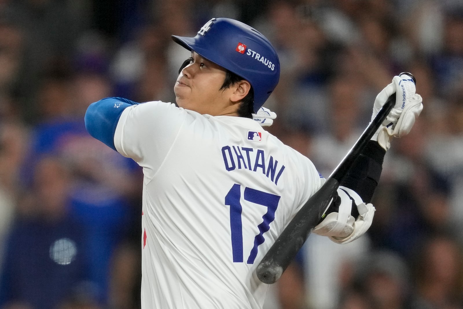 Los Angeles Dodgers' Shohei Ohtani hits RBI-single against the New York Mets during the sixth inning in Game 6 of a baseball NL Championship Series, Sunday, Oct. 20, 2024, in Los Angeles. (AP Photo/Ashley Landis)