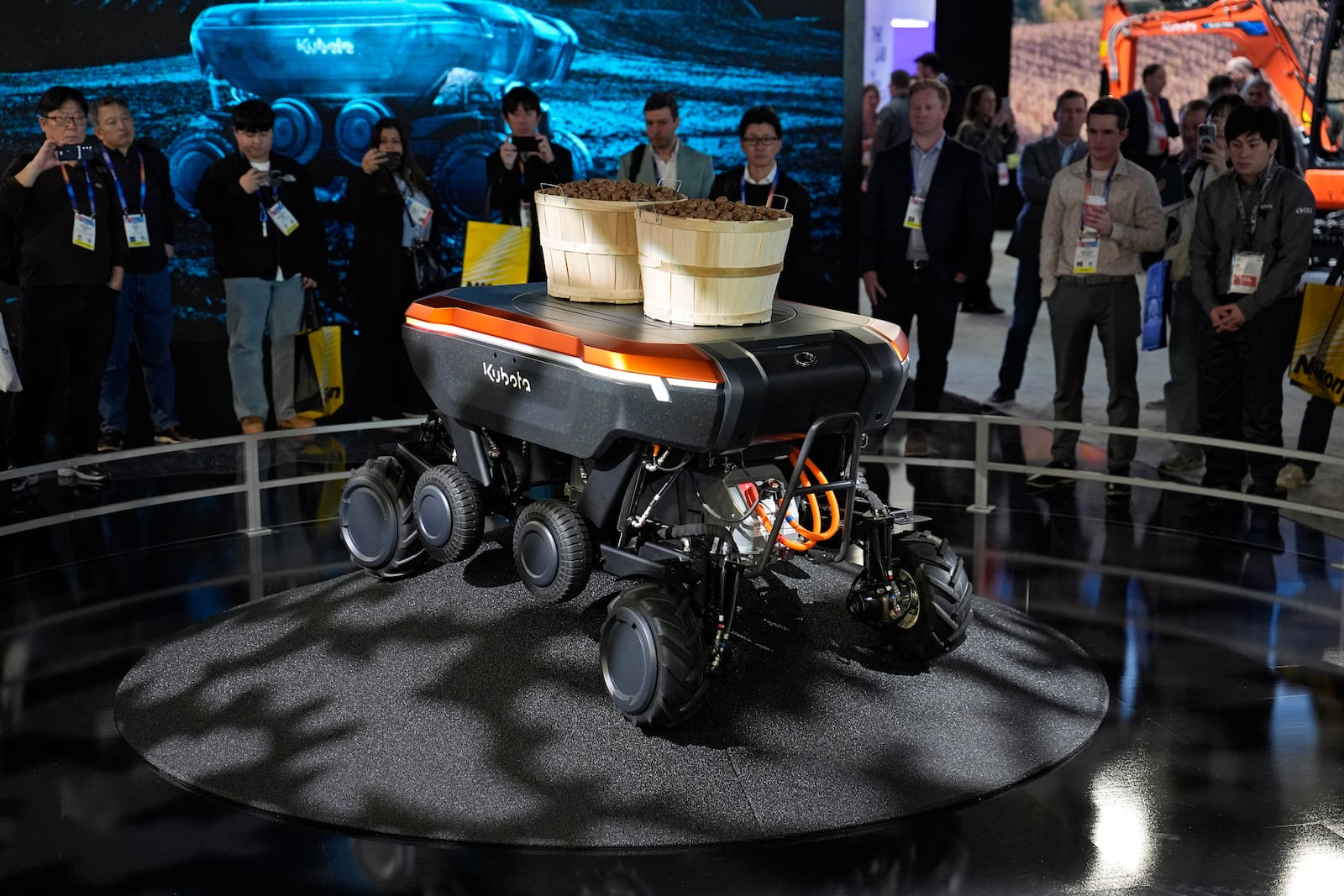 People view a demonstration of the KATR robot designed to work in agriculture and construction at the Kubota booth during the CES tech show Tuesday, Jan. 7, 2025, in Las Vegas. (AP Photo/John Locher)