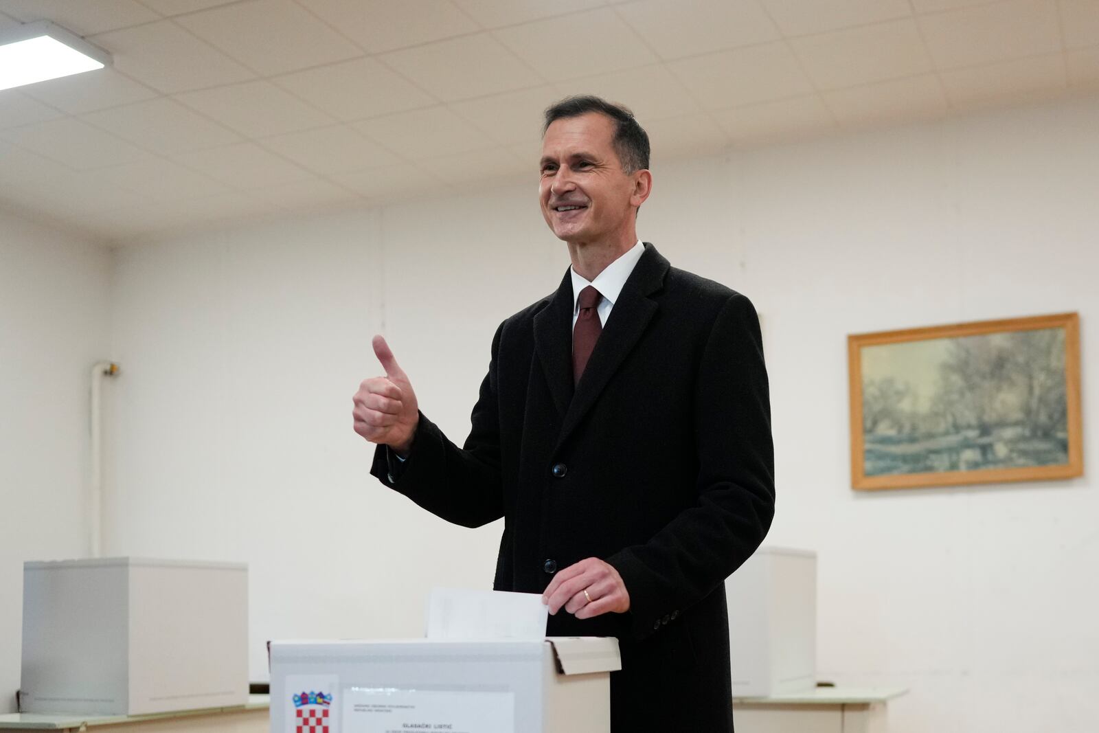 Dragan Primorac, the candidate of the ruling Croatian Democratic Union (HDZ) poses as he casts his ballot during a presidential election at a polling station in Zagreb, Croatia, Sunday, Dec. 29, 2024. (AP Photo/Darko Bandic)