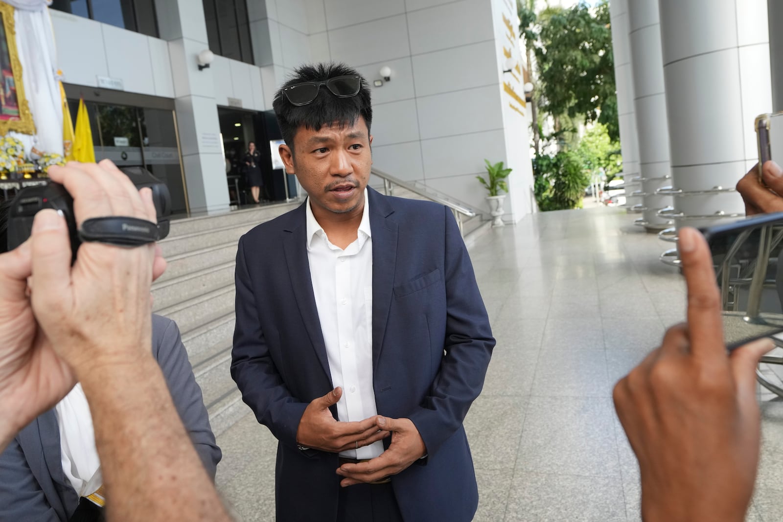 Jatupat Boonpattararaksa talks to reporters before leaving the Civil Court in Bangkok, Thailand, Thursday, Nov. 21, 2024. (AP Photo/Sakchai Lalit)