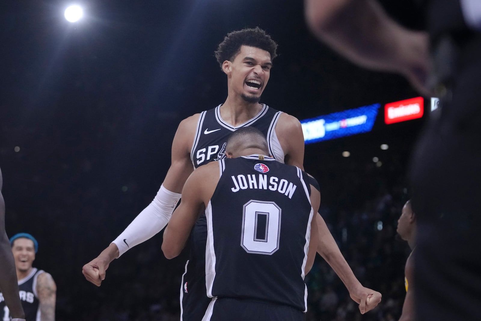 San Antonio Spurs center Victor Wembanyama, top, celebrates with forward Keldon Johnson (0) during the second half of a Paris Games 2025 NBA basketball game against the Indiana Pacers in Paris, Thursday, Jan. 23, 2025. (AP Photo/Thibault Camus)