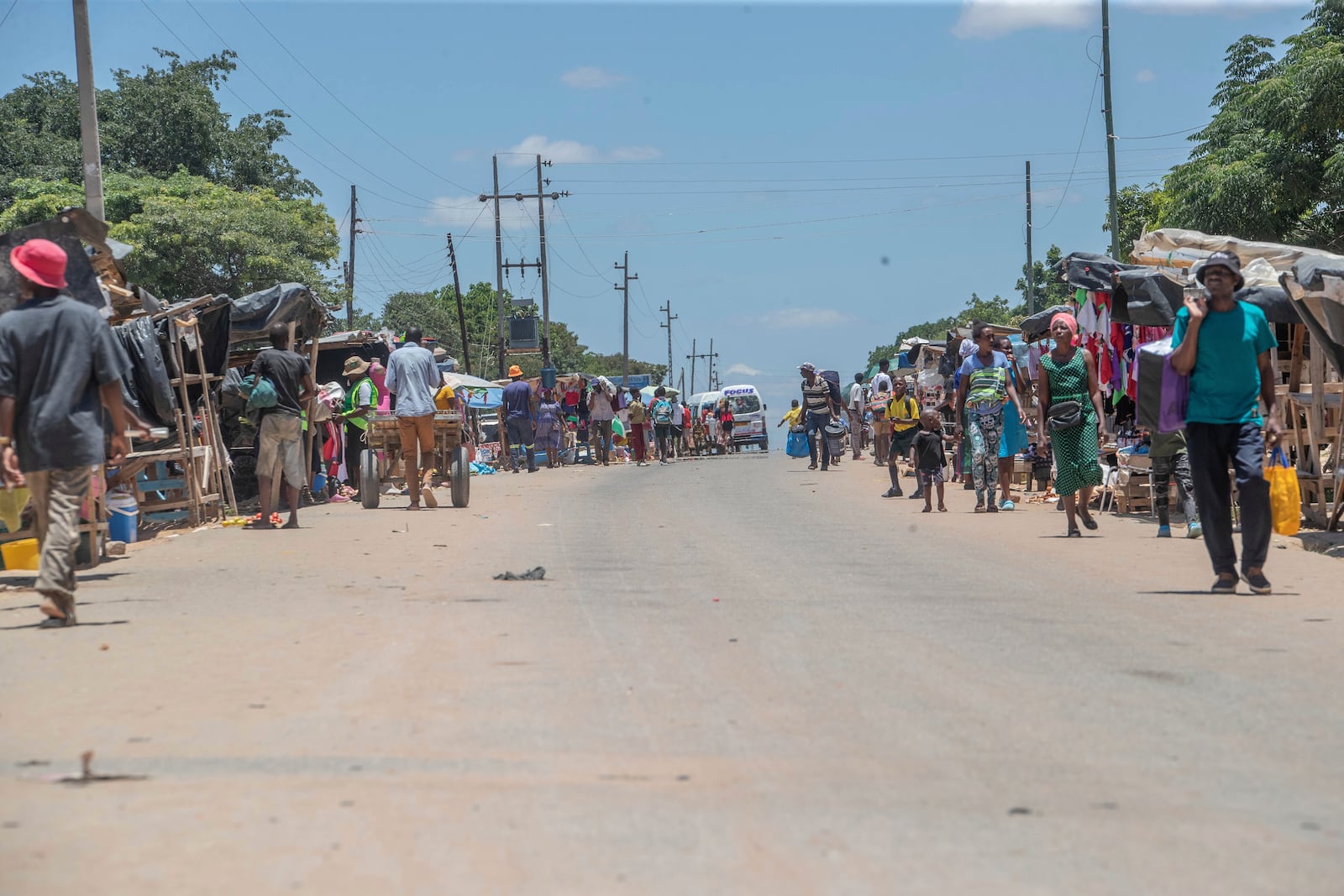 Residents walk in the Epworth neighbourhood of Harare, Zimbabwe, Friday, Feb. 7, 2025. (AP Photo/Aaron Ufumeli)