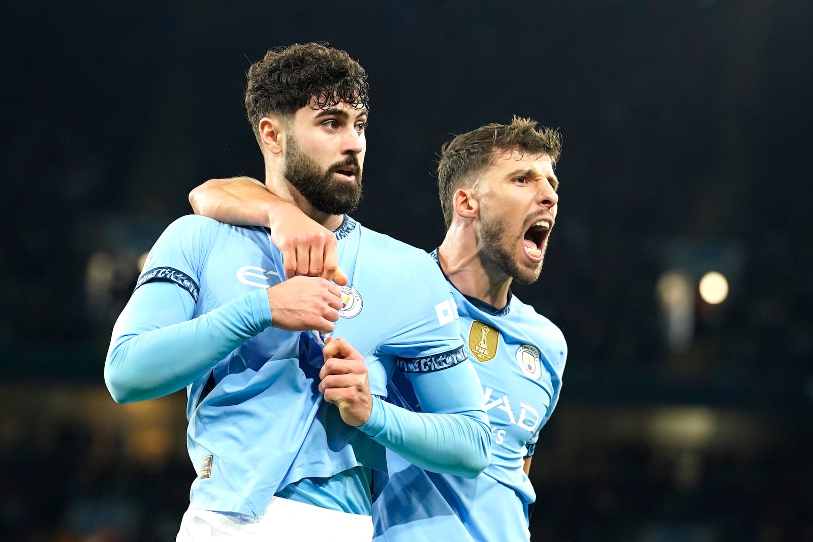 Manchester City's Josko Gvardiol, left, celebrates after scoring his side's opening goal during the English Premier League soccer match between Manchester City and Manchester United at the Etihad Stadium in Manchester, Sunday, Dec. 15, 2024. (AP Photo/Dave Thompson)