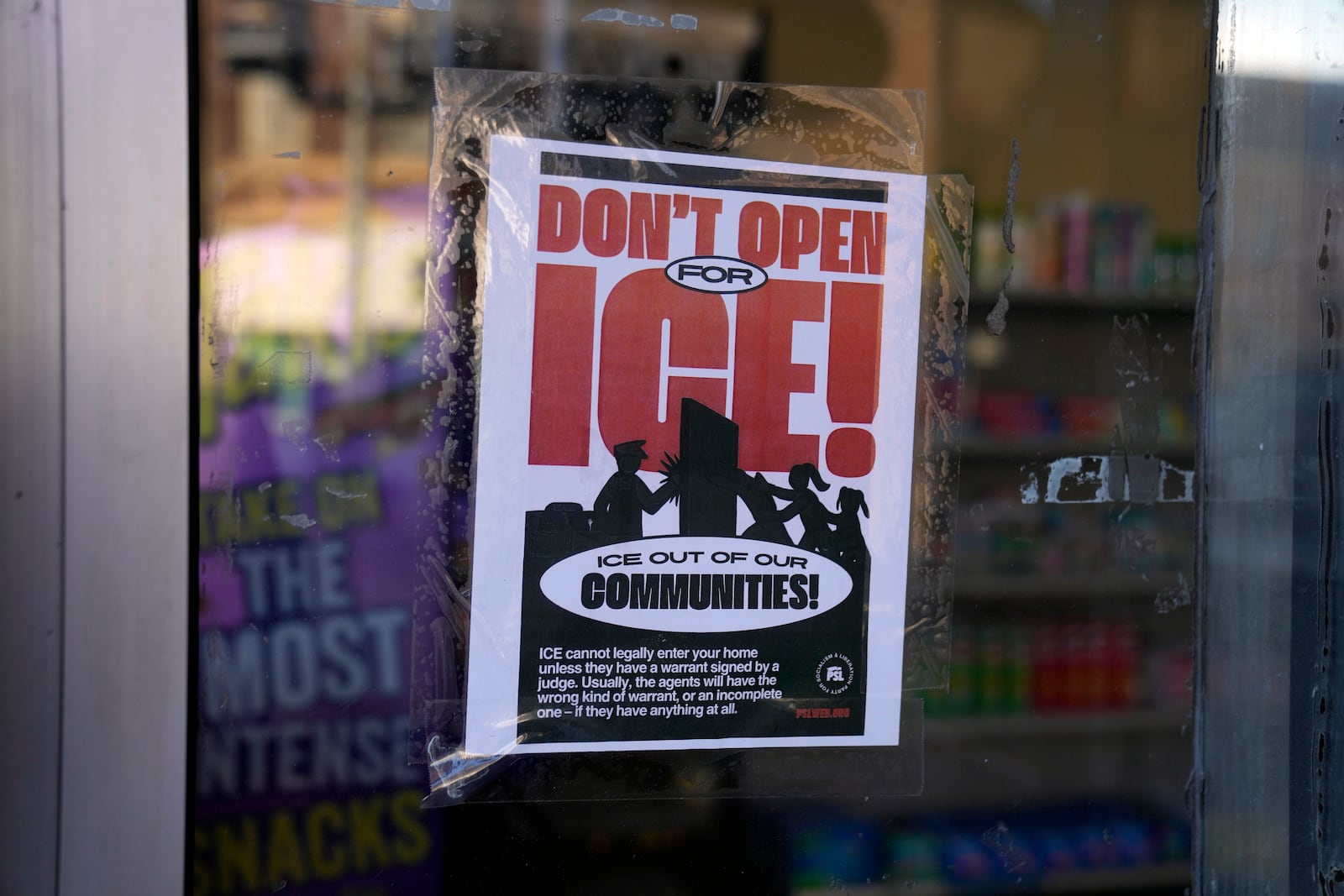 A sign regarding the U.S. Immigration and Customs Enforcement is posted on the window of a corner store on the day of President Trump's Inauguration, Monday, Jan. 20, 2025, in the predominantly Latino Little Village neighborhood Chicago. (AP Photo/Erin Hooley)