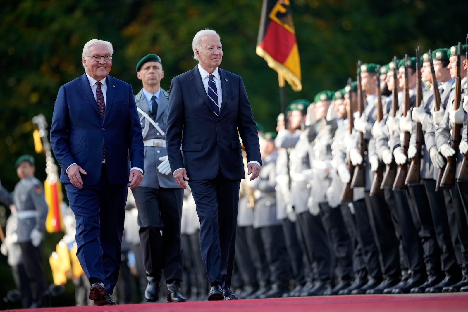 FILE - President Joe Biden and German President Frank-Walter Steinmeier inspect the military honour guard during the welcoming ceremony at Bellevue Palace in Berlin, Germany, on Oct. 18, 2024. (AP Photo/Ebrahim Noroozi, File)