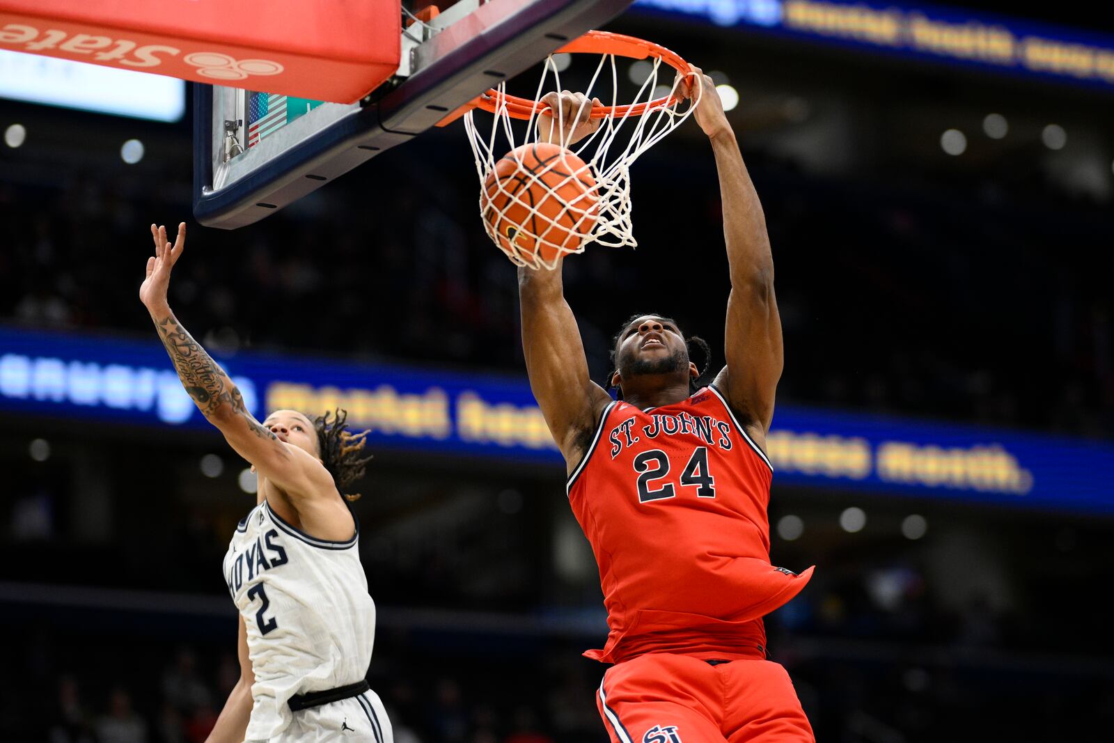 St. John's forward Zuby Ejiofor (24) dunks against Georgetown guard Malik Mack (2) during the second half of an NCAA college basketball game, Tuesday, Jan. 28, 2025, in Washington. (AP Photo/Nick Wass)