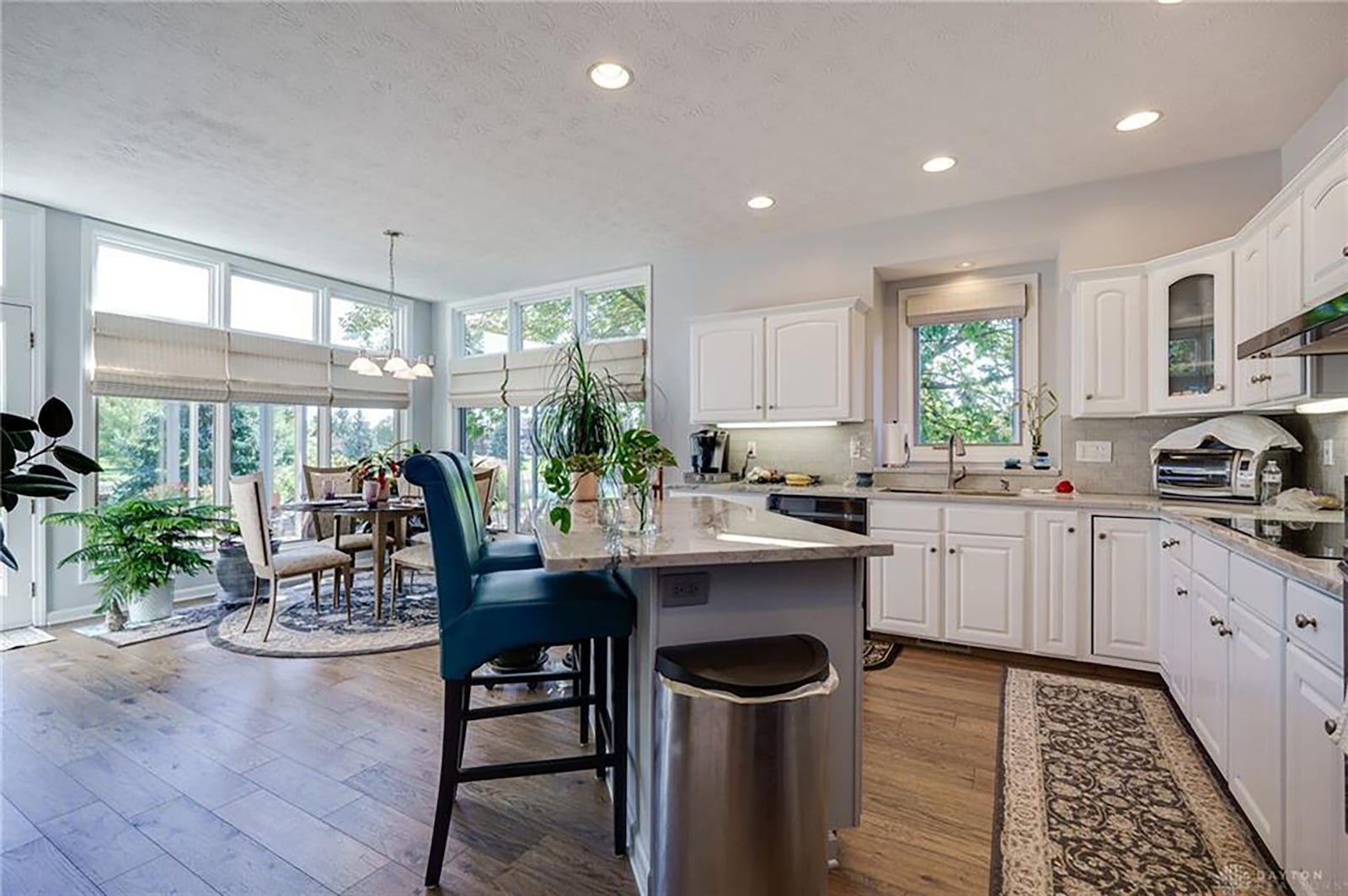 The kitchen has been completely updated with white cabinets, hardwood flooring and breakfast bar/island. It also has a breakfast nook.