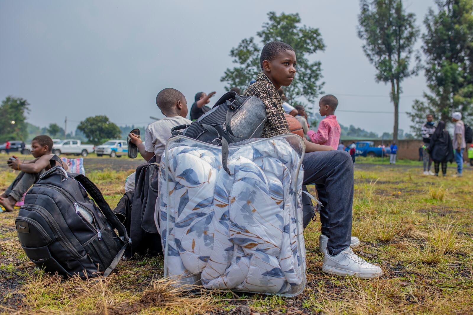 People who crossed from Congo wait for assistance in Gyseny, Rwanda, Tuesday, Jan. 28, 2025, following M23 rebels' advances into eastern Congo's capital Goma. (AP Photo/Yuhi Irakiza)